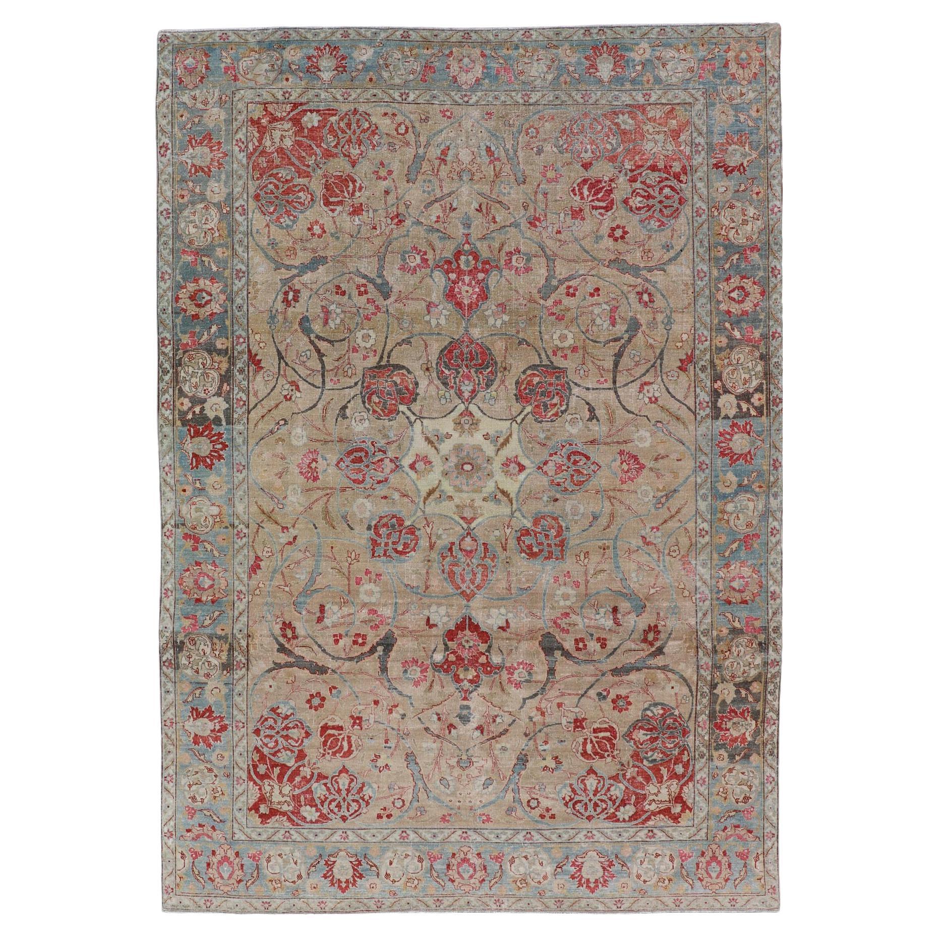 Antique Persian Tabriz Rug with Floral Medallion Design in Tan, Red, and Blue For Sale