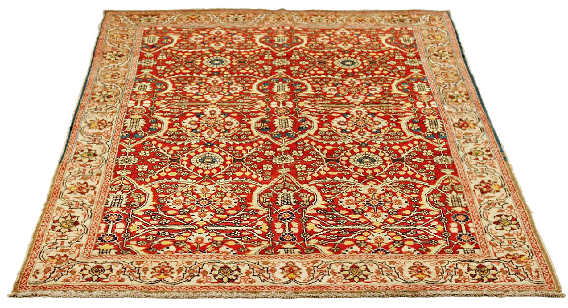 Antique Persian rug handwoven from the finest sheep’s wool and colored with all-natural vegetable dyes that are safe for humans and pets. It’s a traditional Tabriz weaving featuring a lovely ensemble of floral designs in ivory and navy over a red