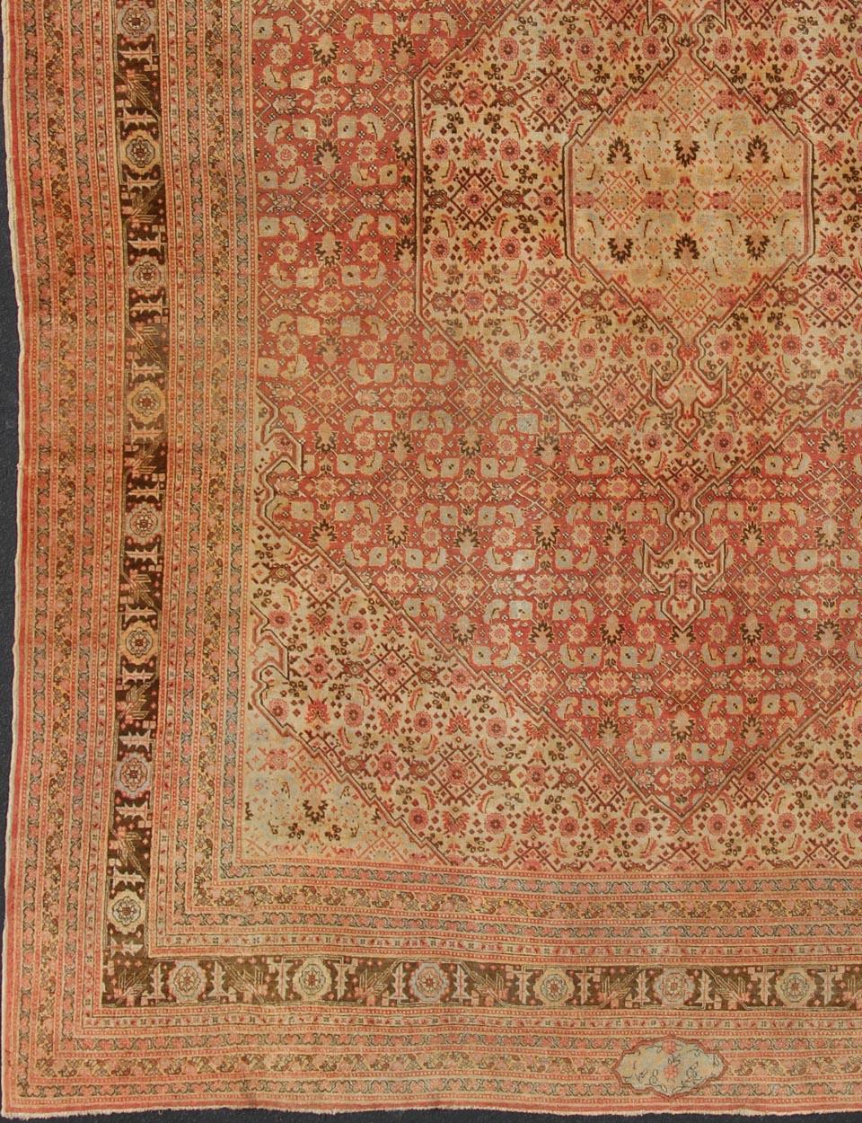 Tabriz antique rug from Persia with all-over design and medallion in multi-colors. Keivan Woven Arts / rug  / 19-0216, country of origin / type: Iran / Tabriz, circa 1900. Antique Persian Tabriz rug with medallion design in coral, cream and brown