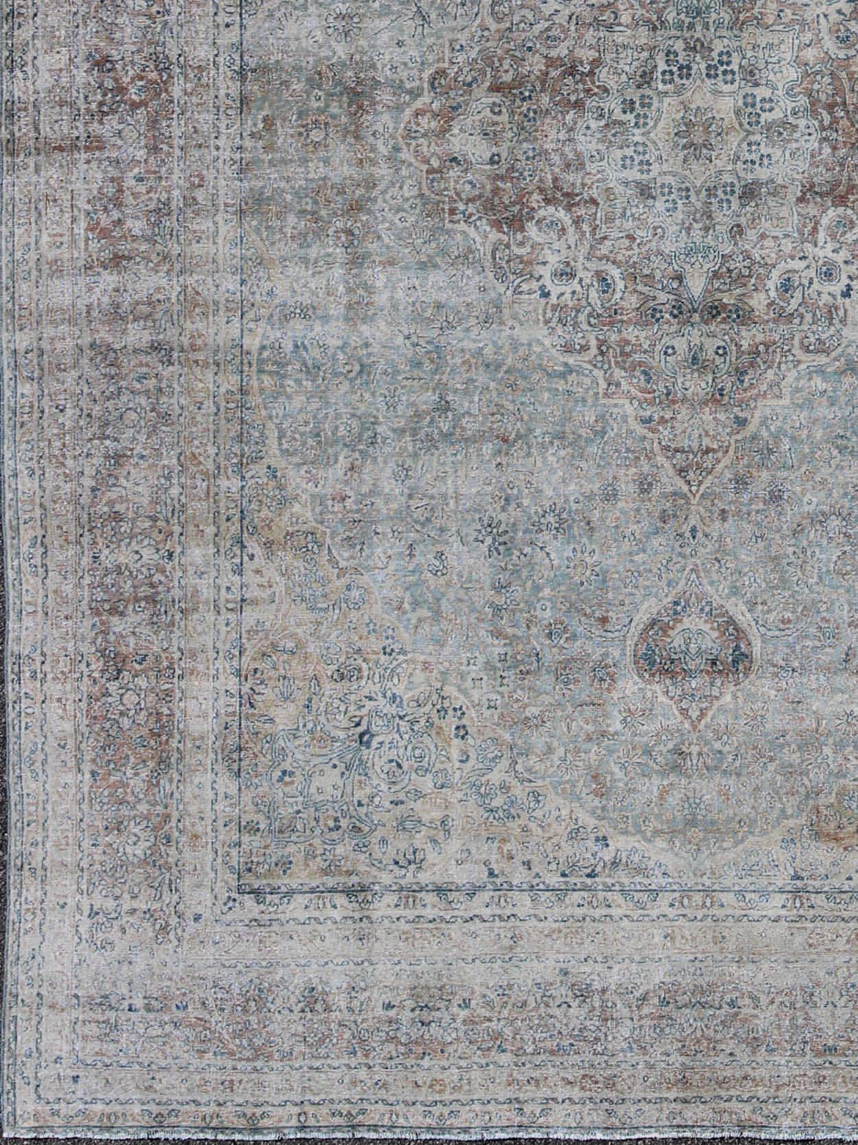 Faded antique Persian Tabriz rug with medallion design in grayish blue, ema-7501, country of origin / type: Iran / Tabriz, circa 1910

This antique Persian Tabriz carpet (circa 1910) features both muted and faded colors and a medallion design set