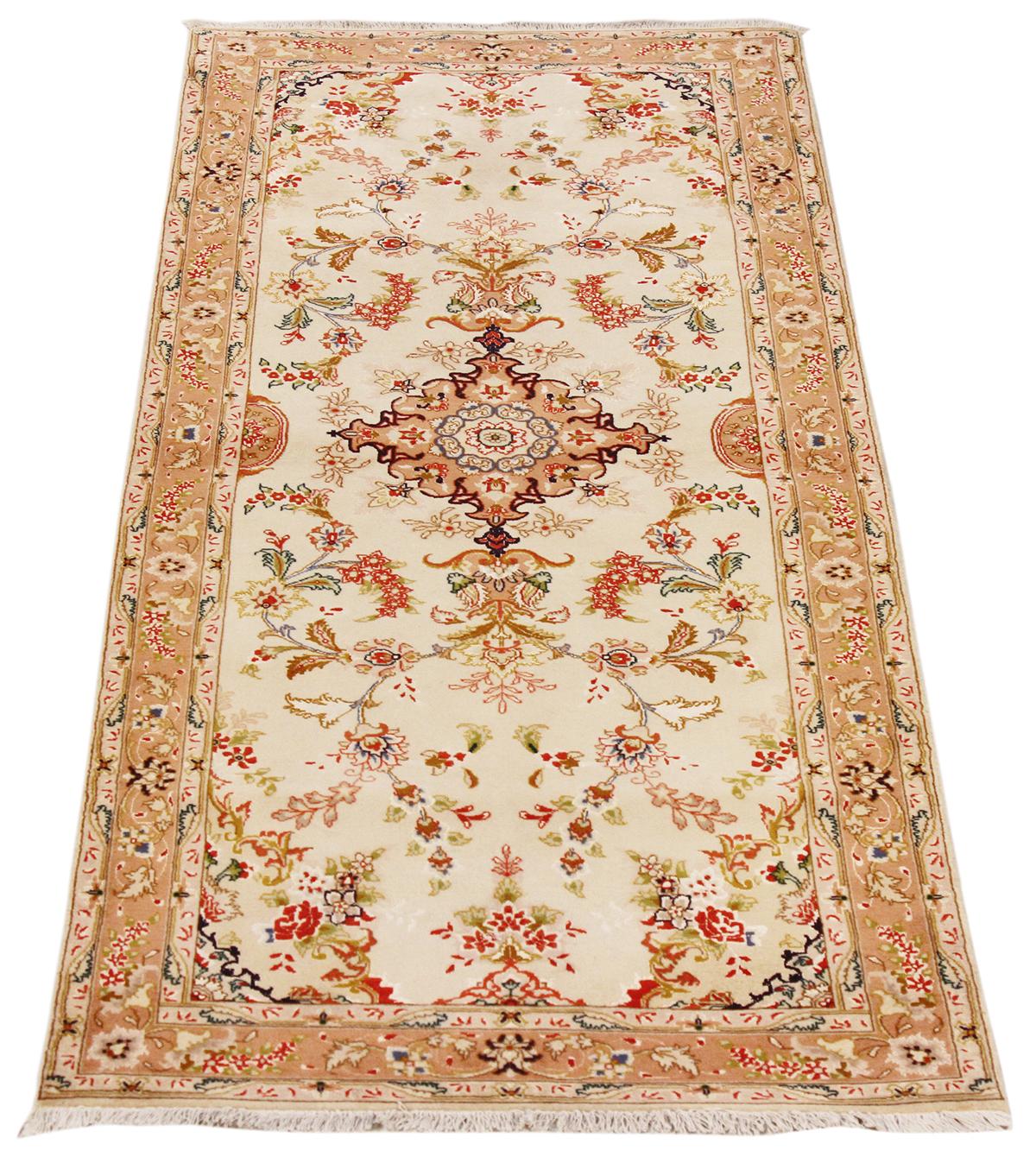 Antique Persian rug handwoven from the finest sheep’s wool and colored with all-natural vegetable dyes that are safe for humans and pets. It’s a traditional Tabriz weaving featuring a lovely ensemble of red and brown floral motifs over an ivory