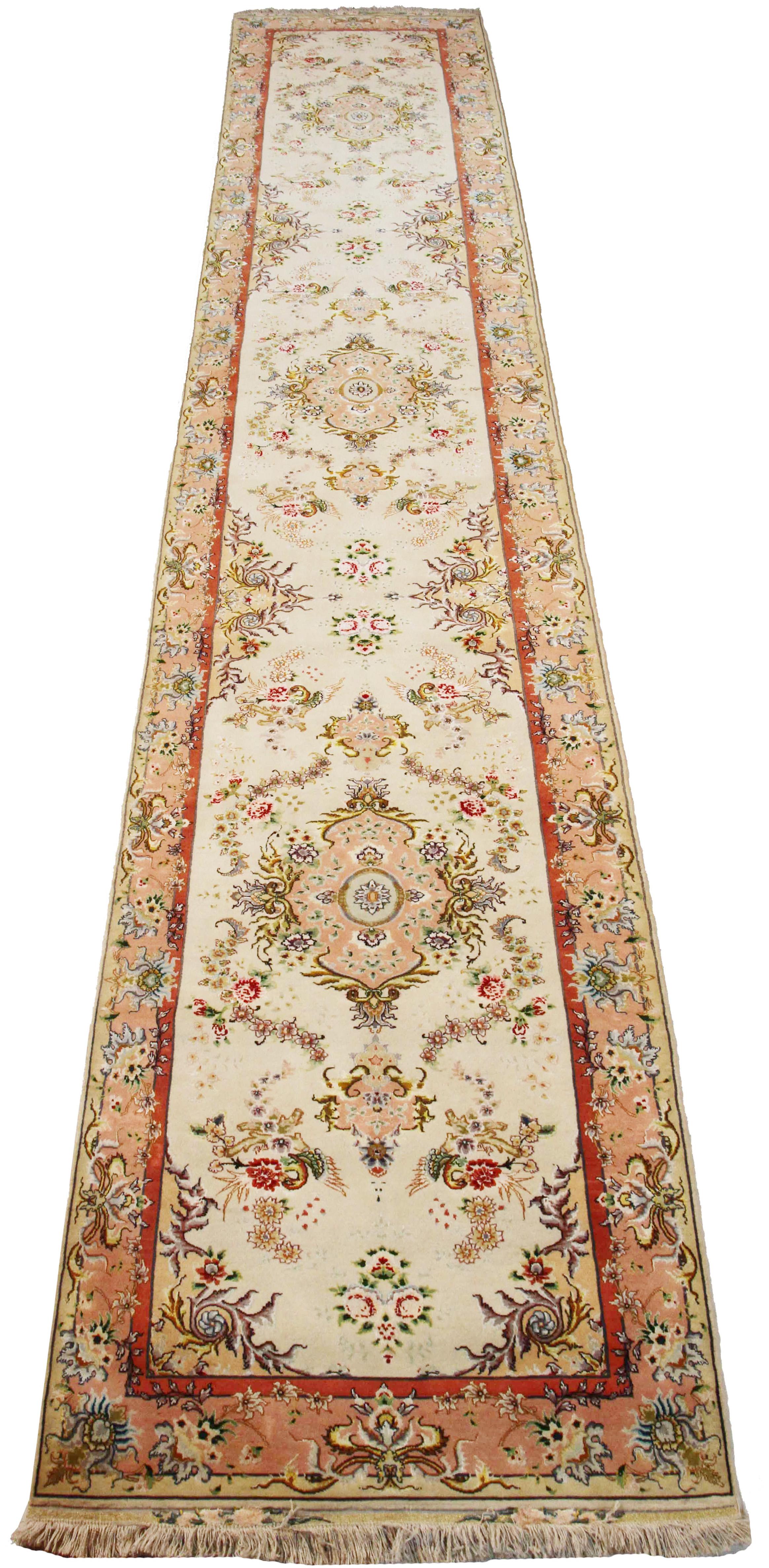 Antique Persian rug handwoven from the finest sheep’s wool and colored with all-natural vegetable dyes that are safe for humans and pets. It’s a traditional Tabriz weaving featuring a lovely ensemble of colorful floral motifs over an ivory field.