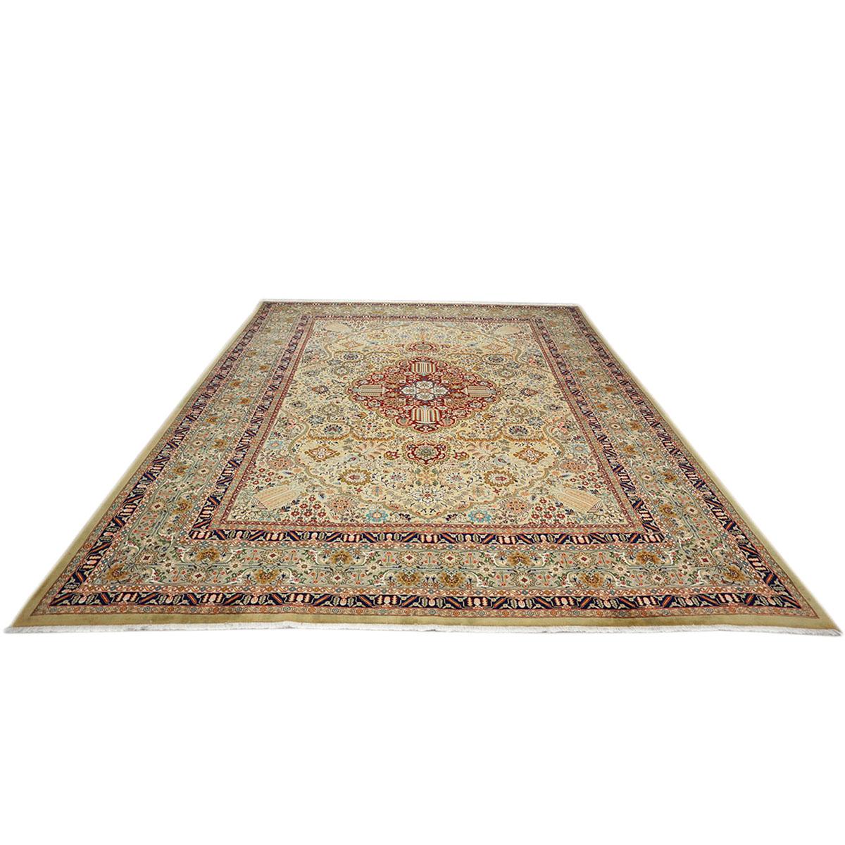 Ashly fine rugs presents a 1930s Antique Persian Tabriz. Tabriz is a northern city in modern-day Iran and has forever been famous for the fineness and craftsmanship of its handmade rugs. This piece has a light tan-colored background and a light gold
