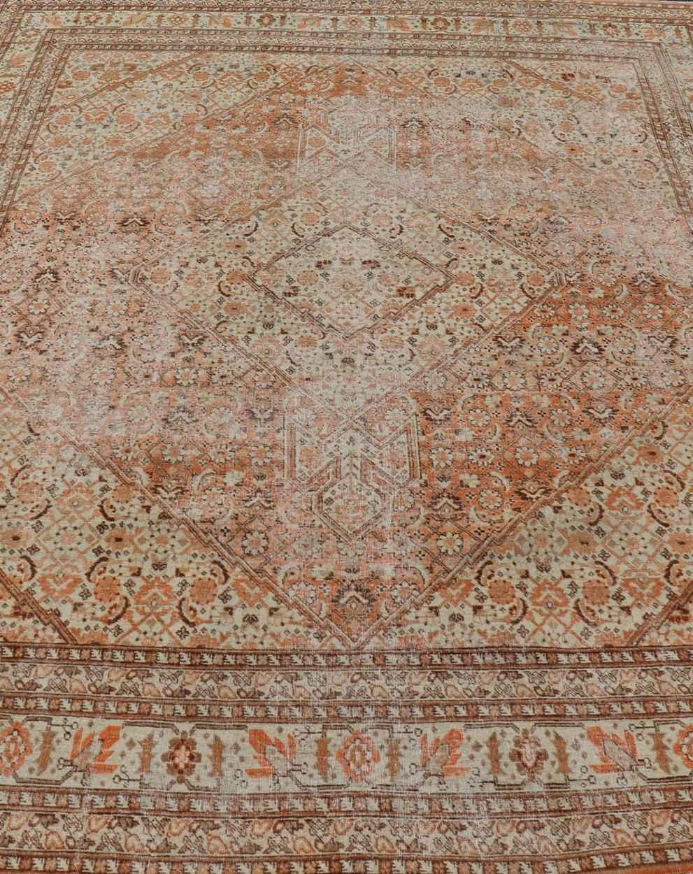 20th Century Antique Persian Tabriz with All-Over Medallion Design in Orange and Browns For Sale