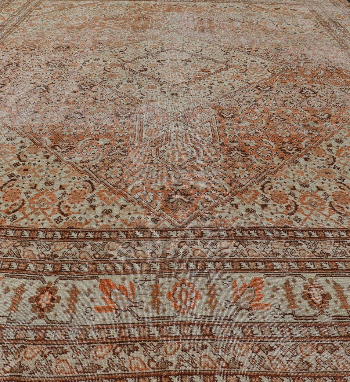 Wool Antique Persian Tabriz with All-Over Medallion Design in Orange and Browns For Sale