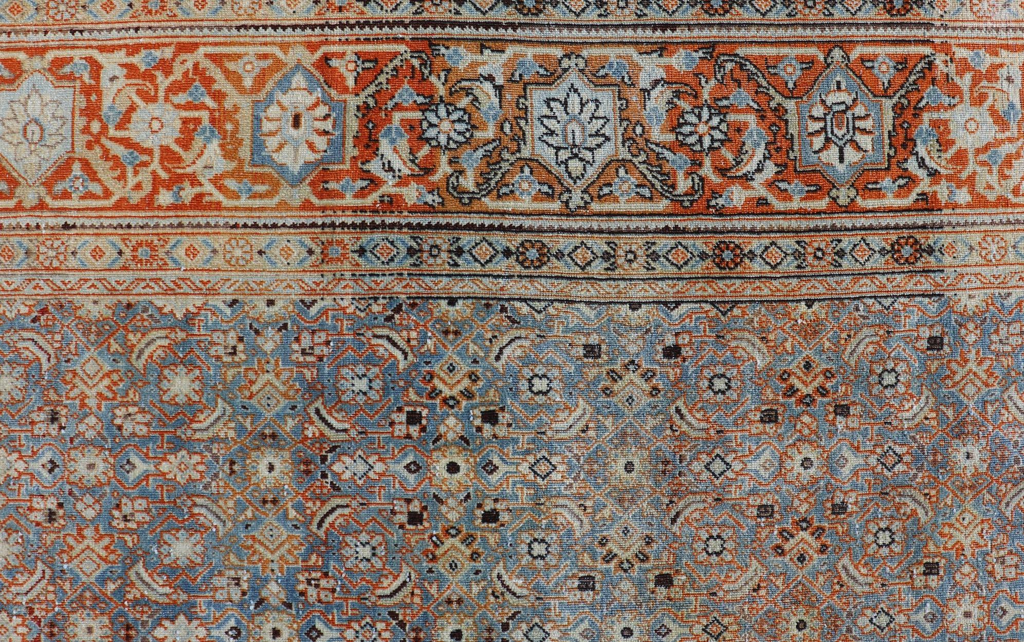 Measures: 7'5 x 11'1 
Antique Persian Tabriz with Sub-Geometric Herati Design in Orange and Blue. Keivan Woven Arts/rug TU-MTU-15161, country of origin / type: Persian / Tabriz, circa 1910s.
This antique Persian Tabriz rug features an all-over,