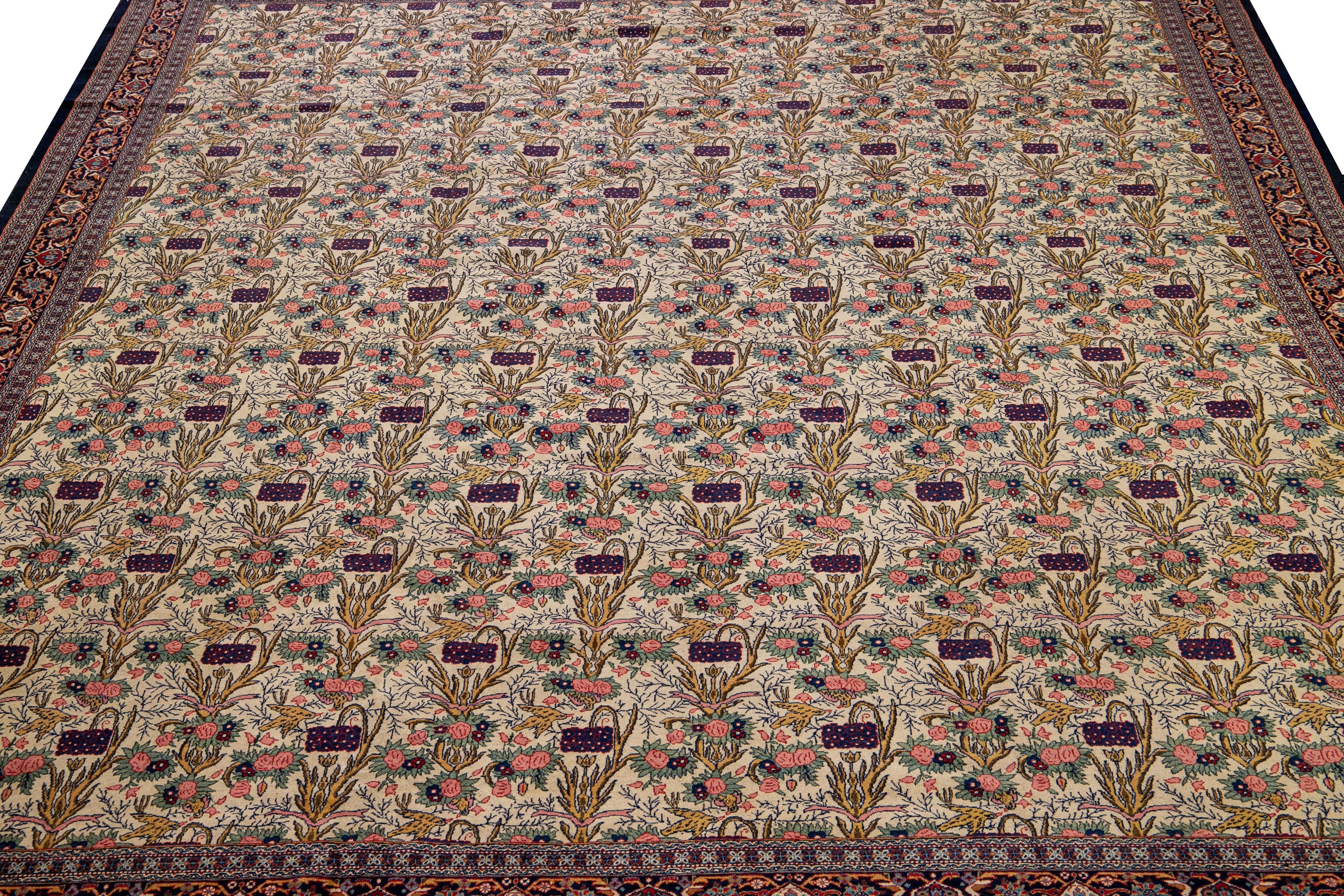 Beautiful antique Persian Tehran hand-knotted Wool rug with a beige field. This antique rug has a navy blue frame and multicolor accents in a gorgeous all-over floral pattern design.

This rug measures: 10'5