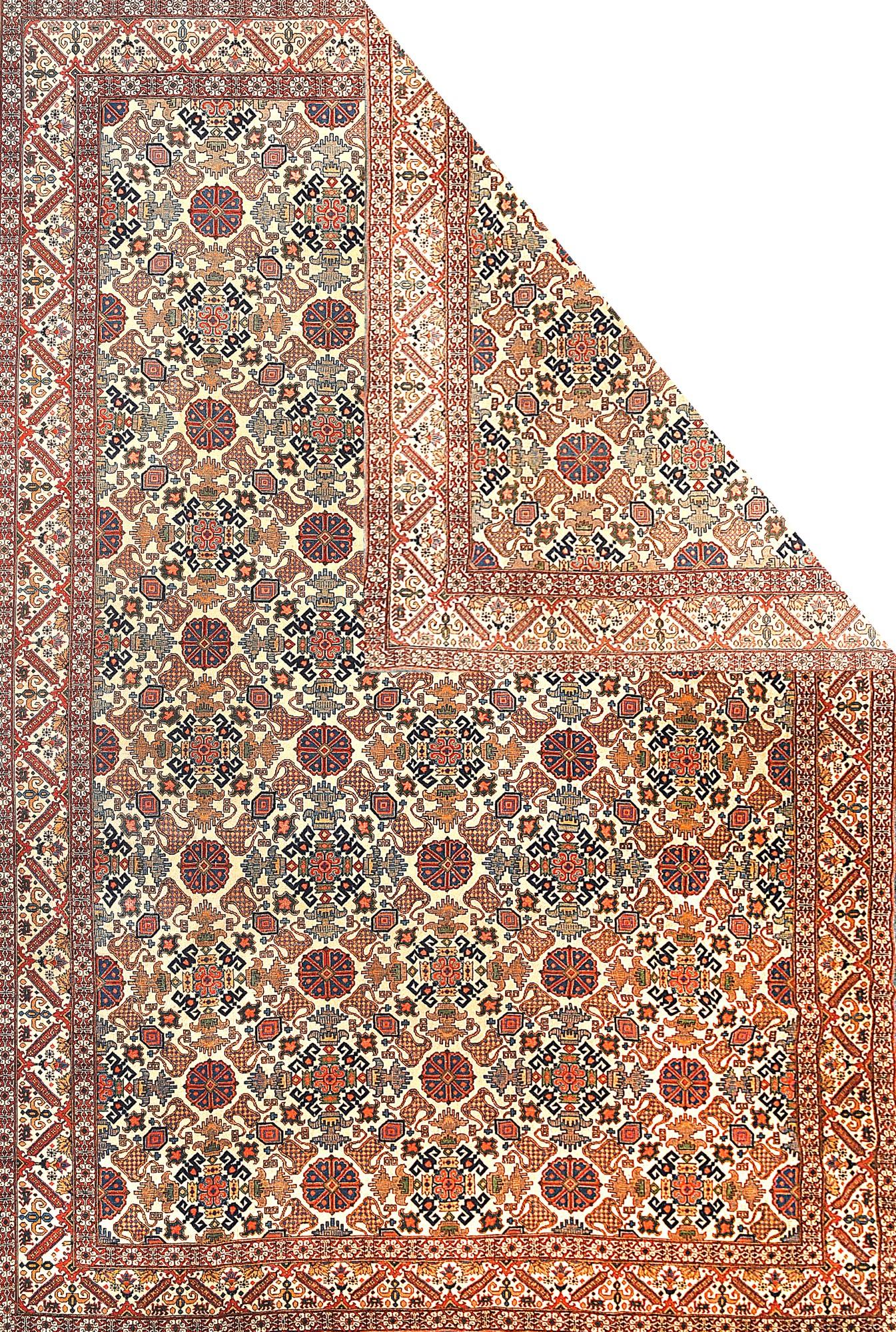 Tehran carpets were woven primarily for the nouveau riches in the Interwar period, as is indicated by the Persian proportions of this finely woven example with an unusual pattern of a broken lattice composed of rosettes diagonally latticed with