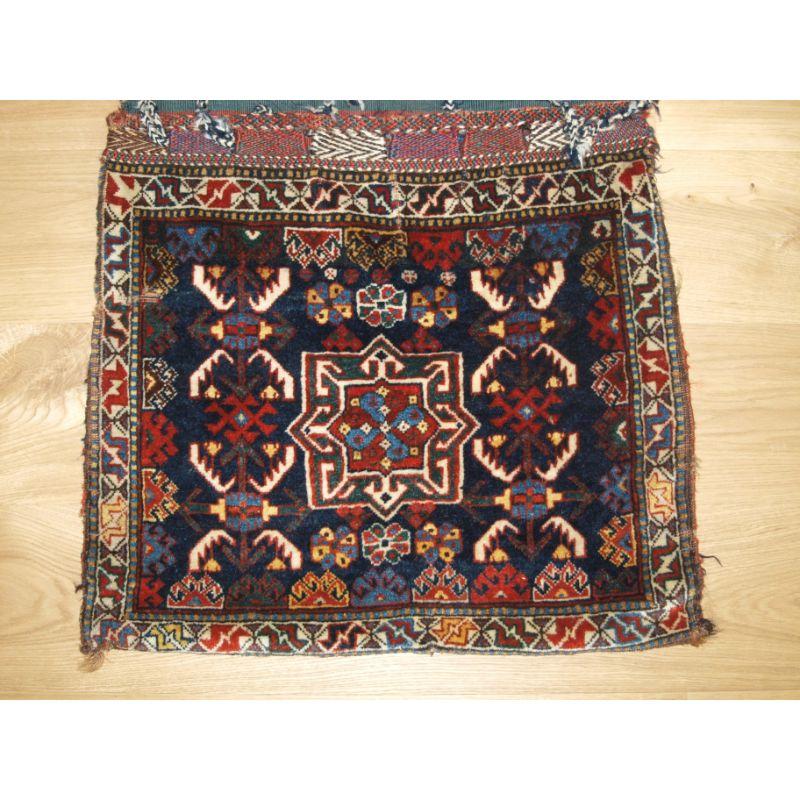Antique Persian tribal Khamseh Khorjin complete with plain weave back.

Circa 1880.

The saddle bag faces are very well drawn with a central medallion surrounded by herati.

The design is found in Khamseh weaving, usually on bags but also on rugs