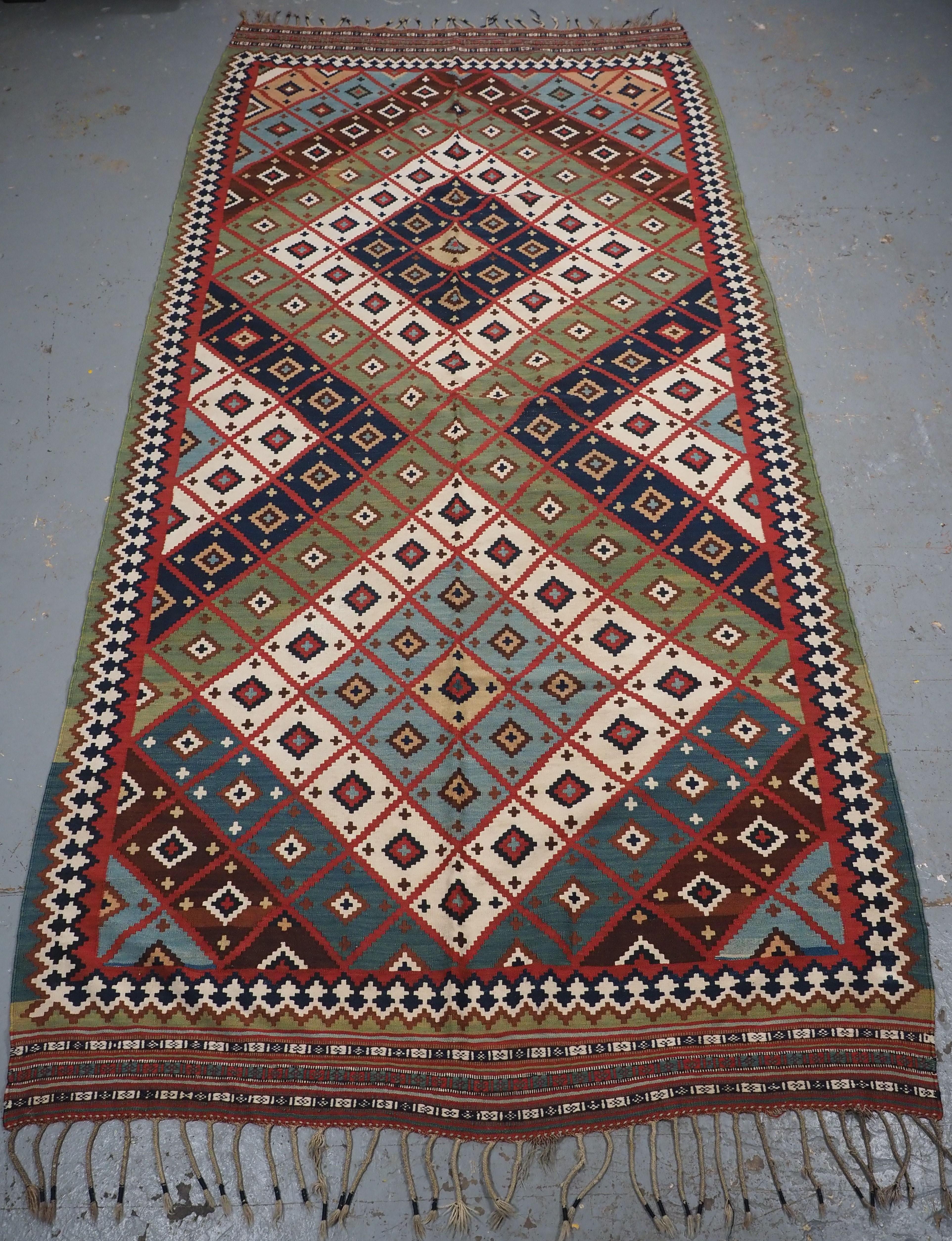 
Size: 11ft 2in x 5ft 5in (340 x 165cm).

Antique Persian tribal Qashqai kilim, South West Persia.

Circa 1890.

A really outstanding Qashqai kilim with very bold diamond lattice design and wonderful natural dye colours throughout including a scarce