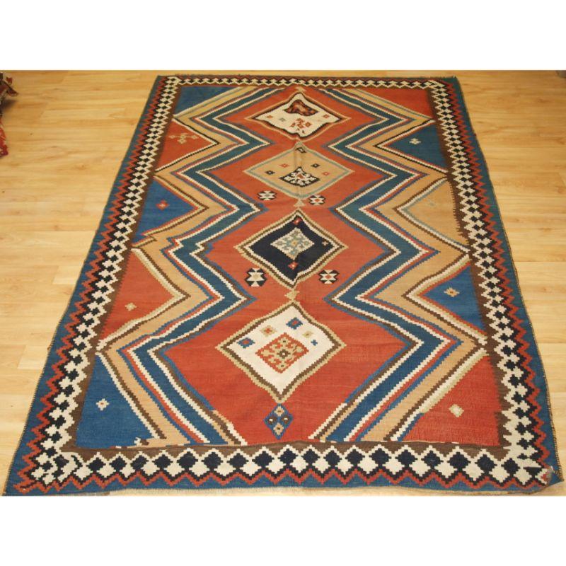Antique Persian tribal Qashqai kilim, South West Persia.

A good Qashqai kilim with very bold eye dazzler design, natural dye colours throughout. Some of the whites are in cotton.

Excellent condition, very slight wear.

Hand washed and ready for