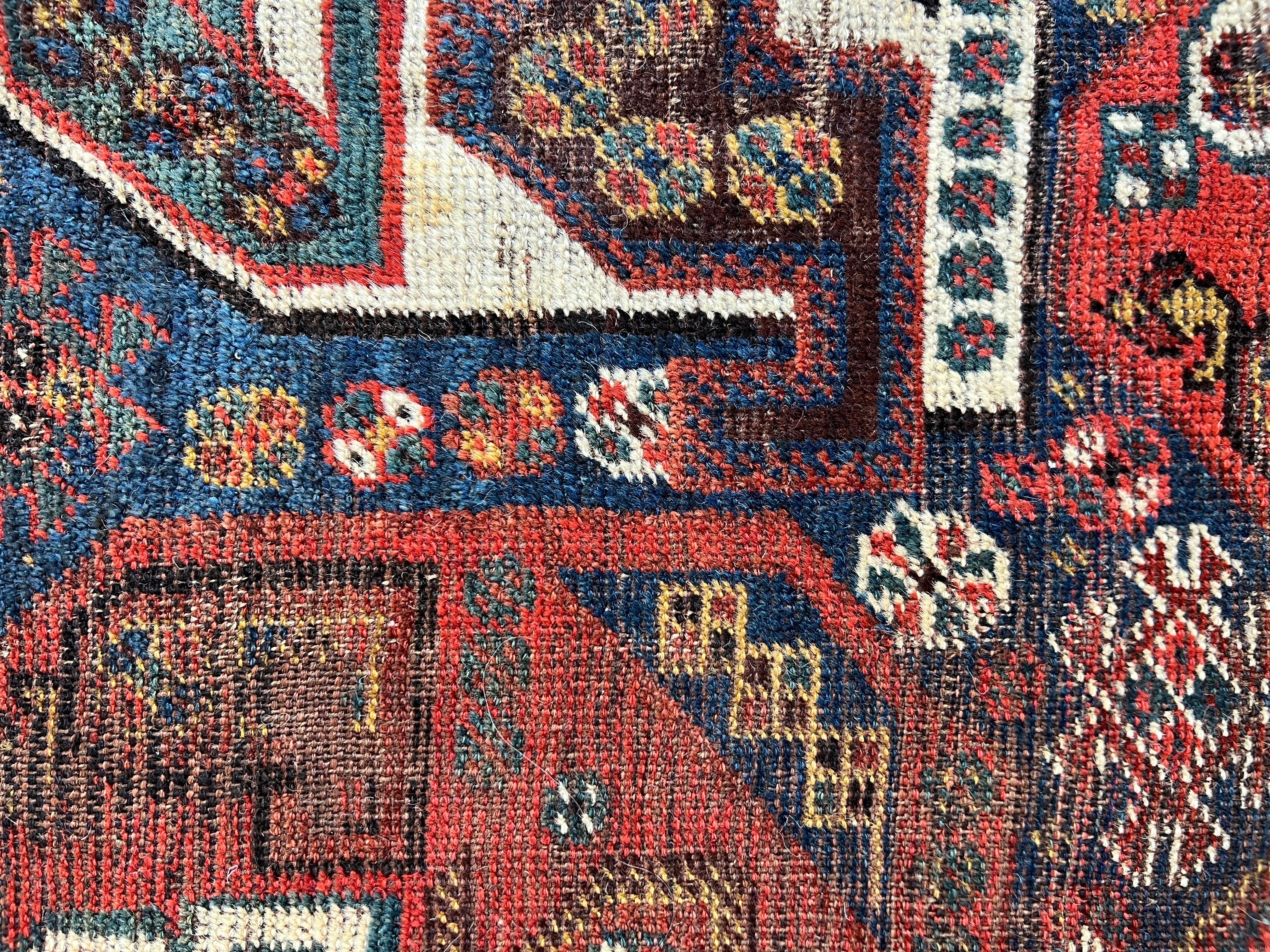 20th Century Antique Persian Tribal Shiraz Rug with a Repeating All over Pattern For Sale