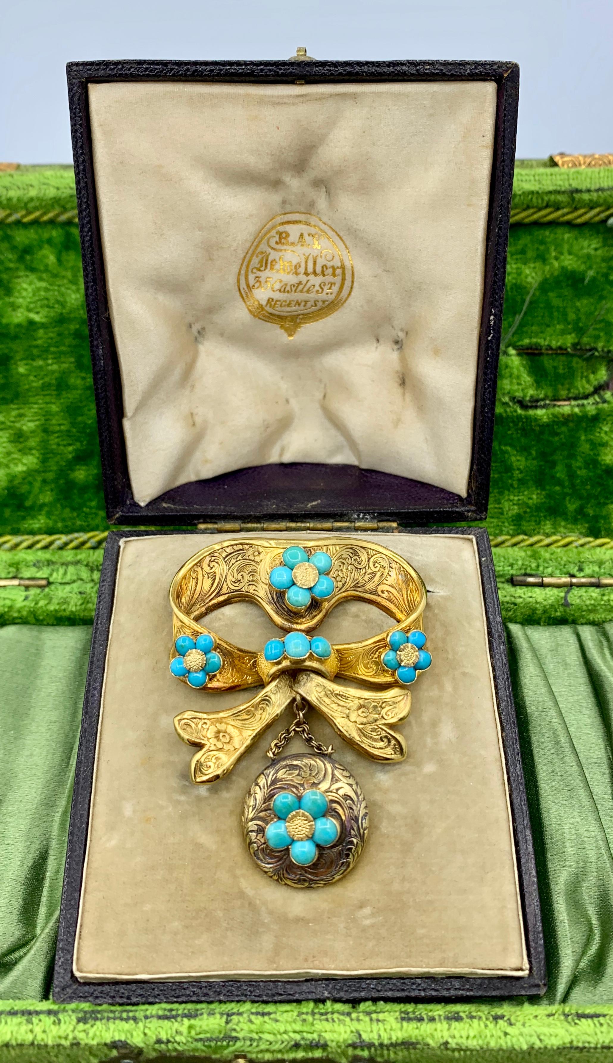 This is a stunning early Victorian - Georgian Antique 14 Karat Gold and Turquoise Bow Forget Me Not Flower Brooch with a hanging locket pendant.  The 23 round Persian Turquoise cabochons are absolutely exquisite.  The jewels are set in Forget Me Not