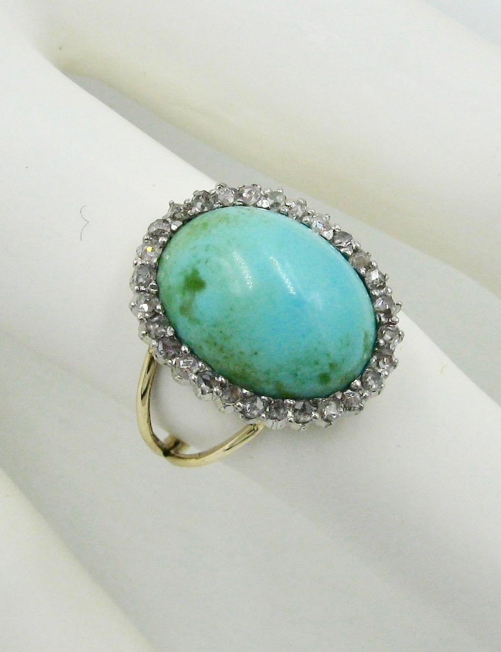 An Antique Edwardian Ring with a gorgeous Persian Turquoise cabochon of stunning beauty. The Turquoise is surrounded by a halo of 30 sparkling Rose Cut Diamonds. The jewels are set in Platinum atop 14 Karat Gold. One of my favorite rings! The