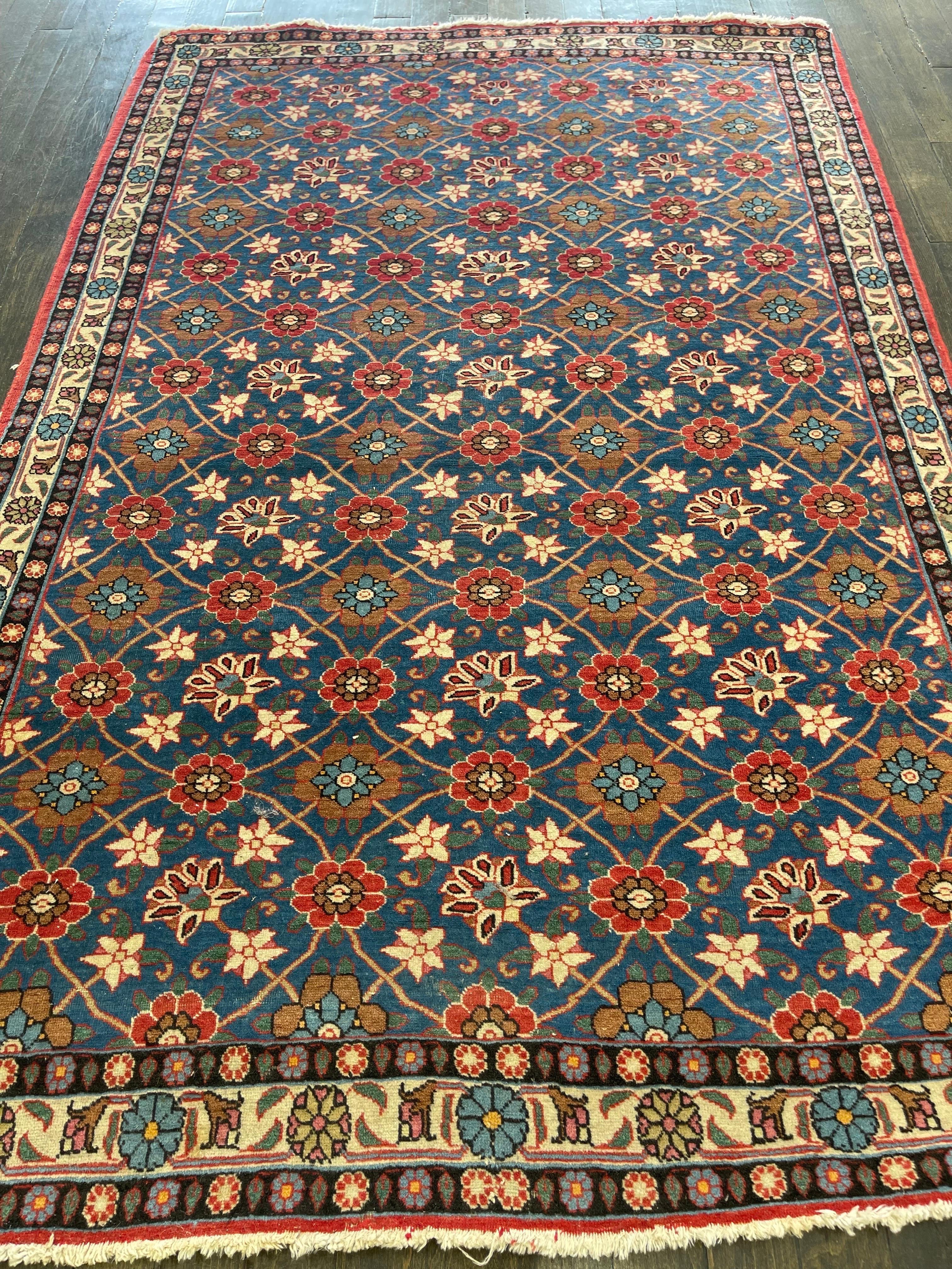 A gem created in Iran's central north, this rug features the renowned Mina Khani design, on a light blue field with ivory border and two guard borders all decorated with small Rossetts.

The 