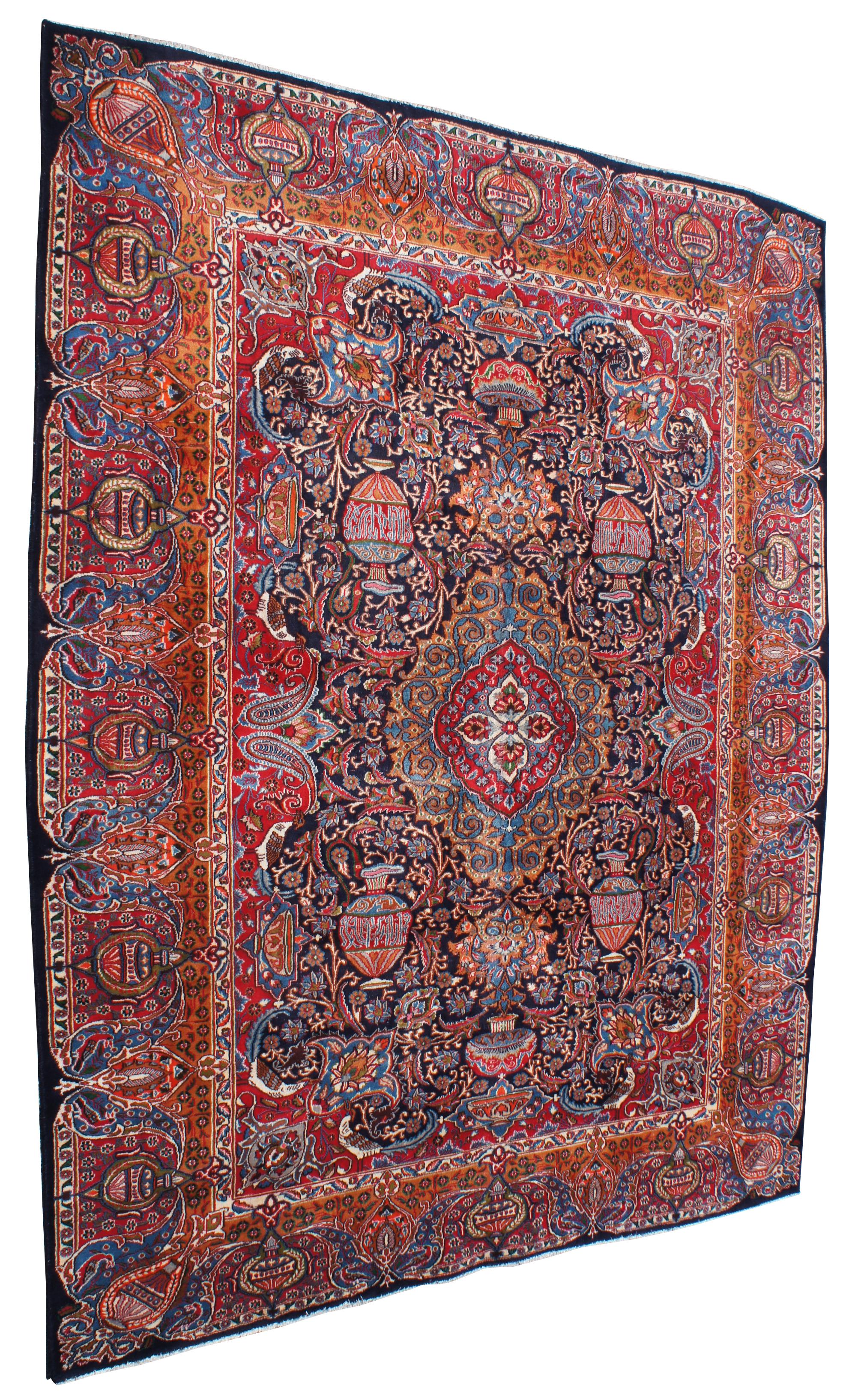 Antique hand knotted Persian rug featuring a field of reds and blues with ornaments, trophy urns or vases, various birds and floral accents. Shades of reds, blues, orange, cream or beige, greens and browns.
   