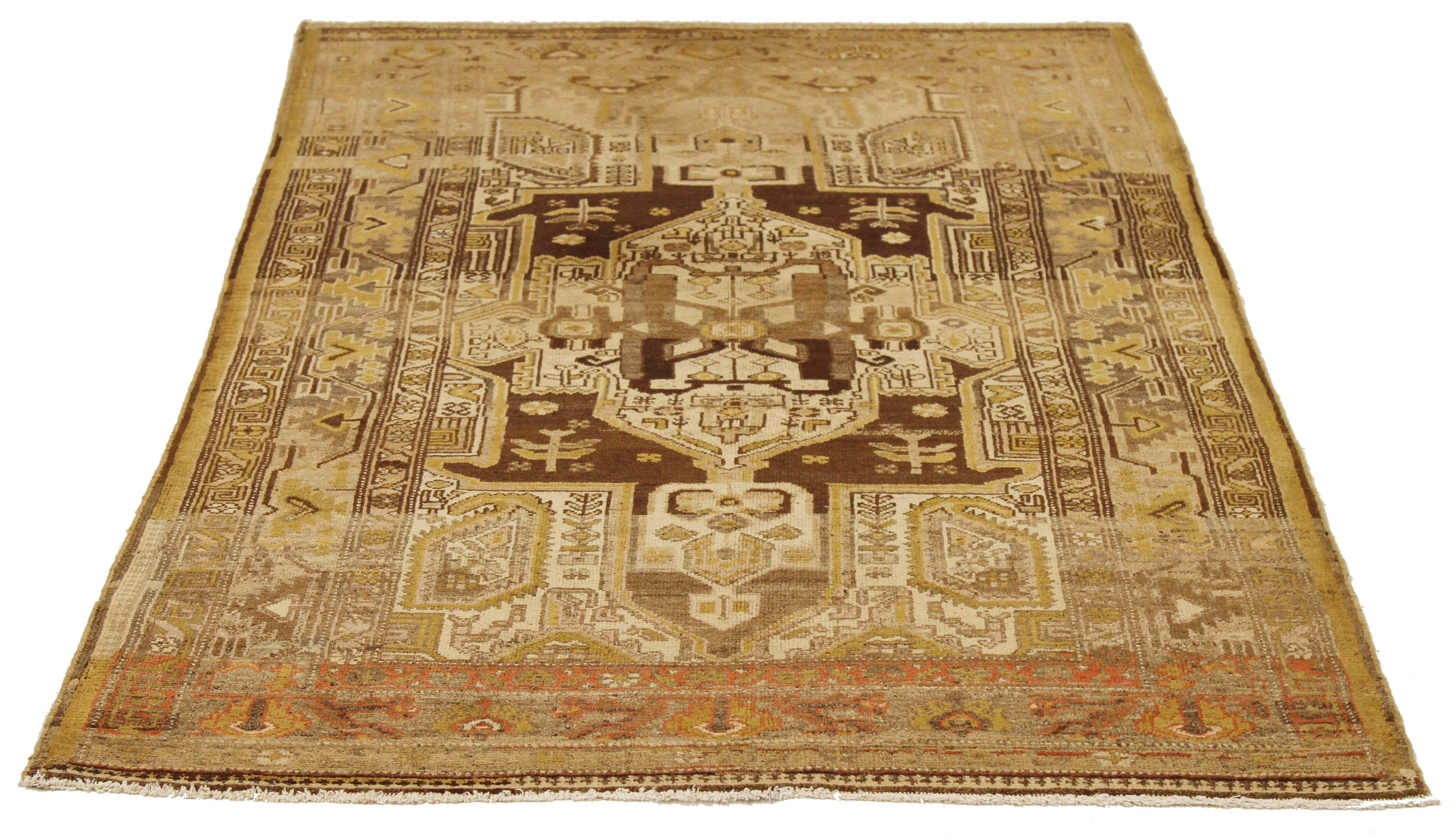 Antique Persian rug handwoven from the finest sheep’s wool and colored with all-natural vegetable dyes that are safe for humans and pets. It’s a traditional Zanjan design featuring geometric and floral details in brown and gold on an ivory field.