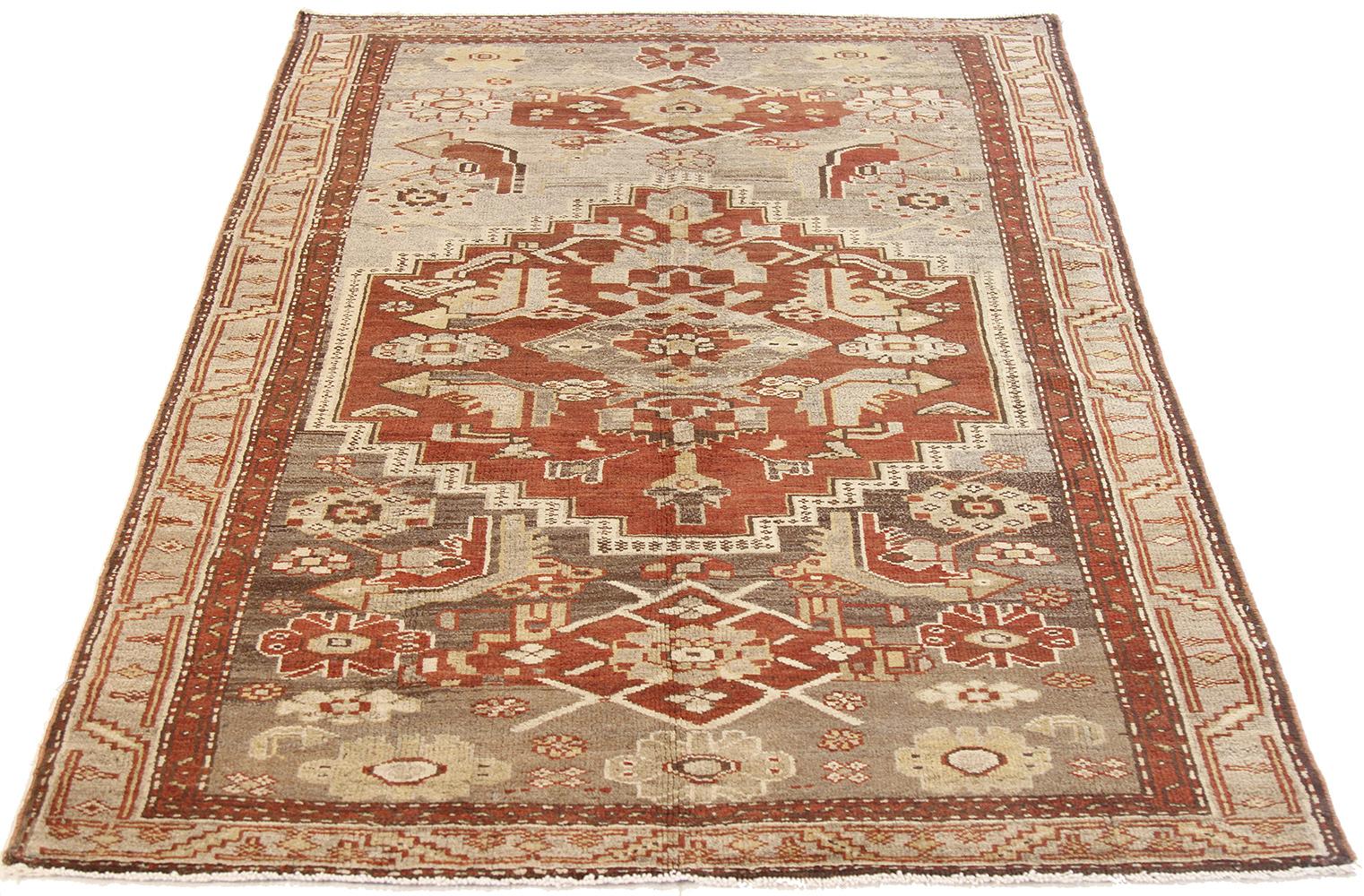 Antique Persian rug handwoven from the finest sheep’s wool and colored with all-natural vegetable dyes that are safe for humans and pets. It’s a traditional Zanjan design featuring geometric tribal details in red and beige on an ivory field. It’s a