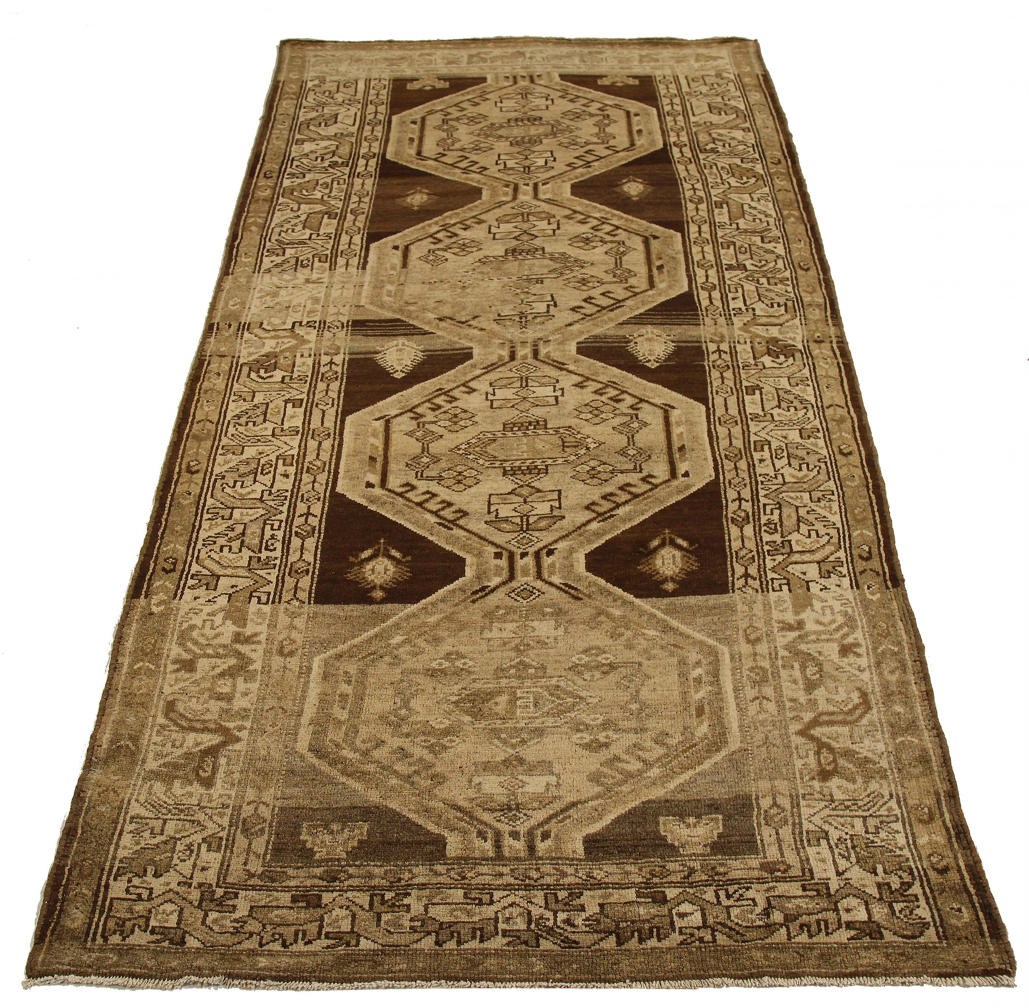 Antique Persian area rug handwoven from the finest sheep’s wool. It’s colored with all-natural vegetable dyes that are safe for humans and pets. It’s a traditional Zanjan design featuring geometric-tribal details on a beige field. It’s a lovely