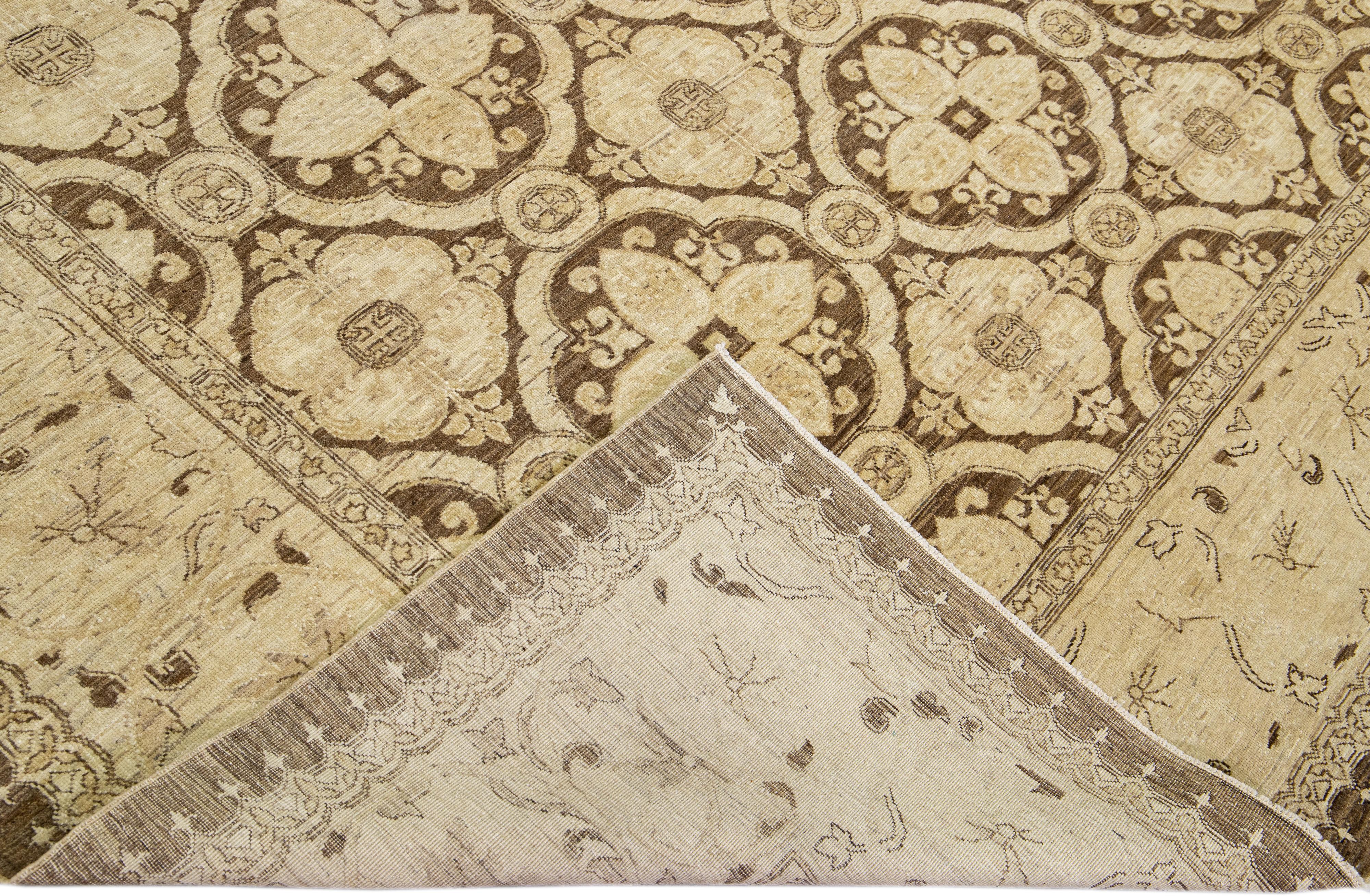 Beautiful hand-knotted antique Peshawar wool rug with the brown field. This Persian rug has a beige frame and accents featuring an all-over traditional floral design. 

This rug measures 8'9