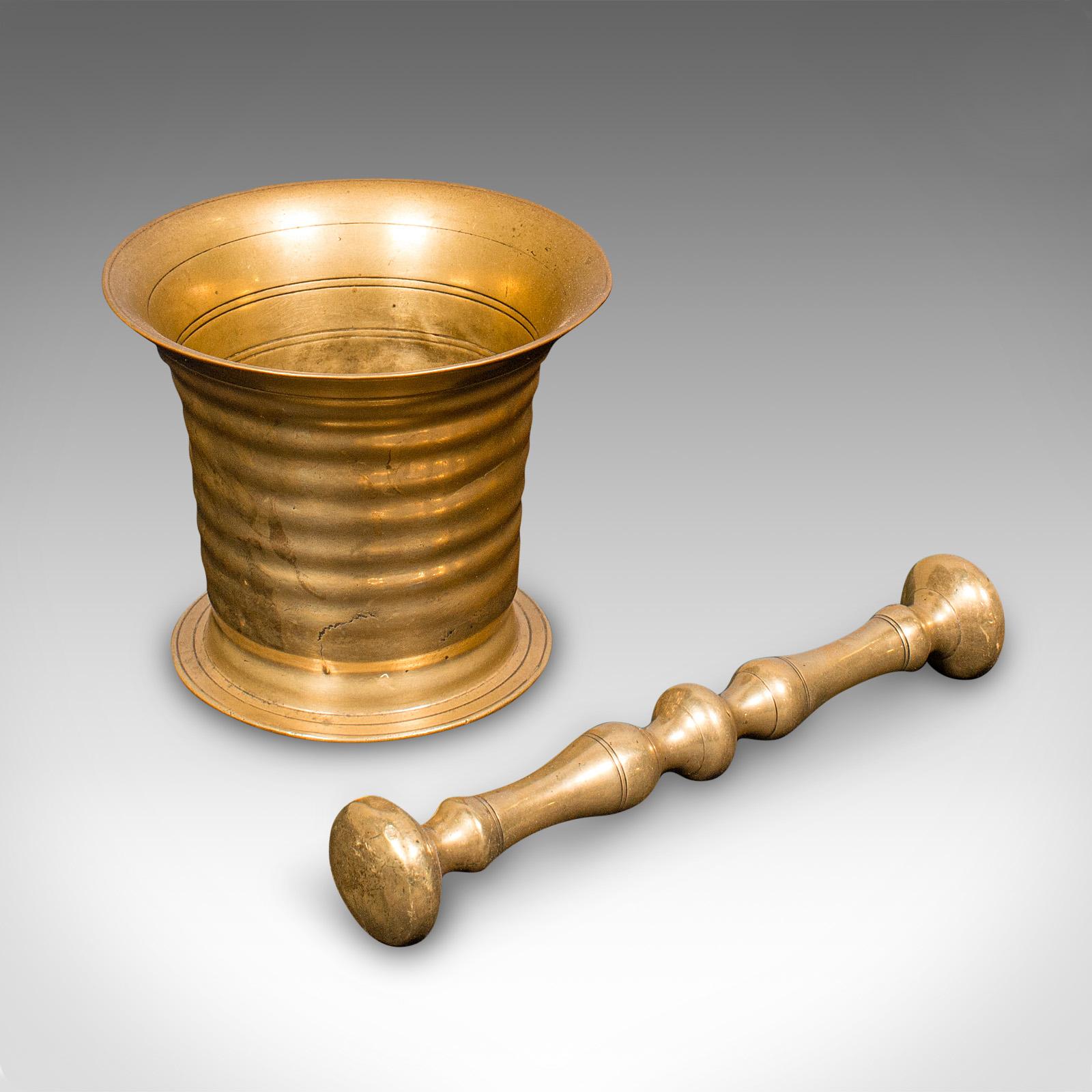 
This is an antique pestle and mortar set. An English, brass chemist shop instrument, dating to the early Victorian period, circa 1850.

Dashing Victorian pestle and mortar with fine display appeal
Displays a desirable aged patina and in good