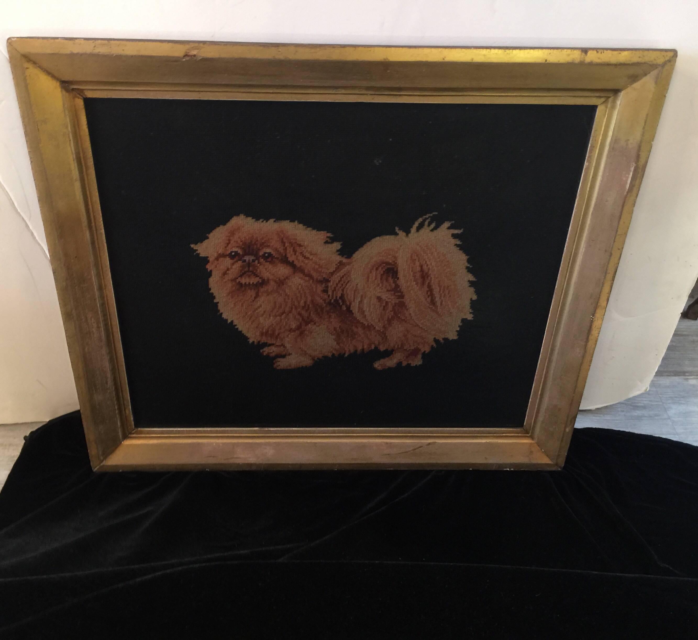 Antique petit point Pekingese dog with needlepoint background in a gold leaf frame. Has original glass and in very good original condition, circa 1890s.