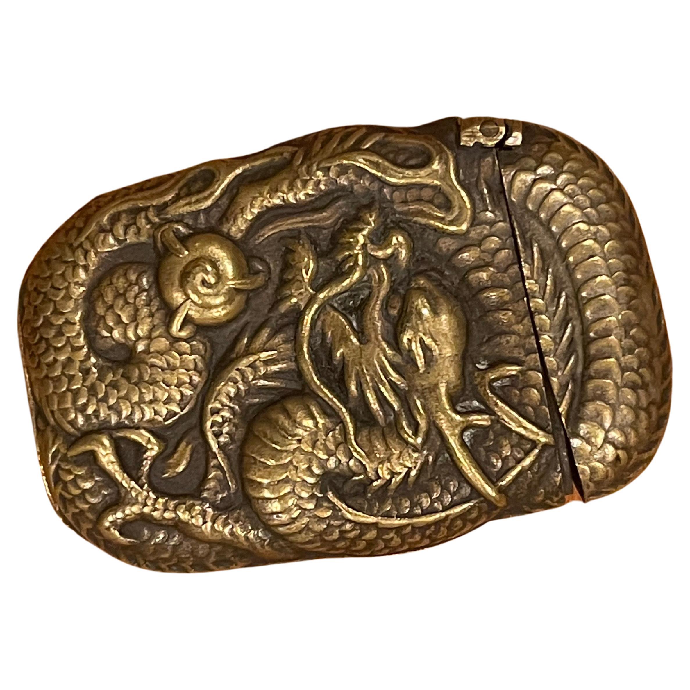 Antique petite bronze dragon / griffin pattern repousse match safe / vesta with an ornate all-over design on both sides, circa 1900s. The match holder measures 1.75