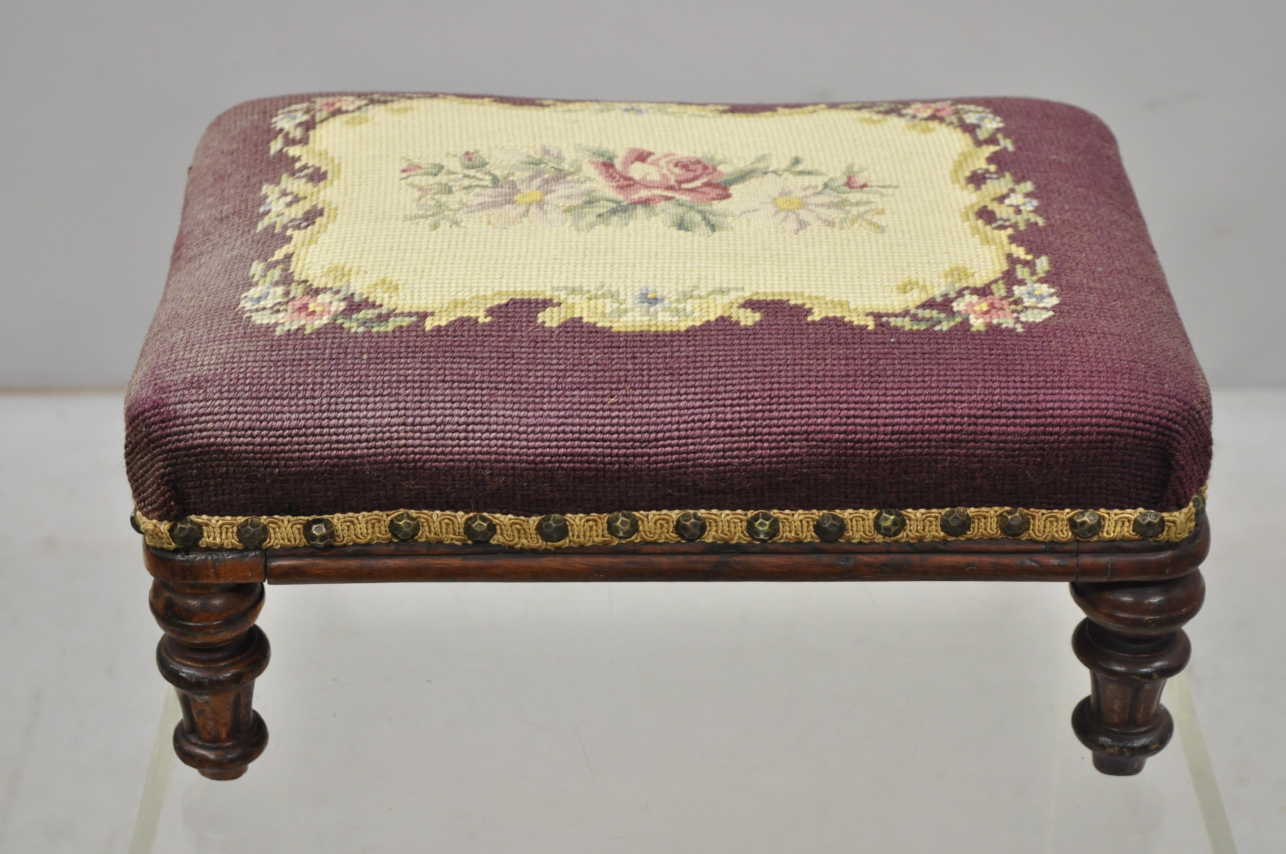 Antique petite small Victorian Empire mahogany needlepoint footstool ottoman. Item includes a floral needlepoint seat, solid wood frame, beautiful wood grain, nicely carved details, tapered legs, very nice antique item, circa late 19th-early 20th
