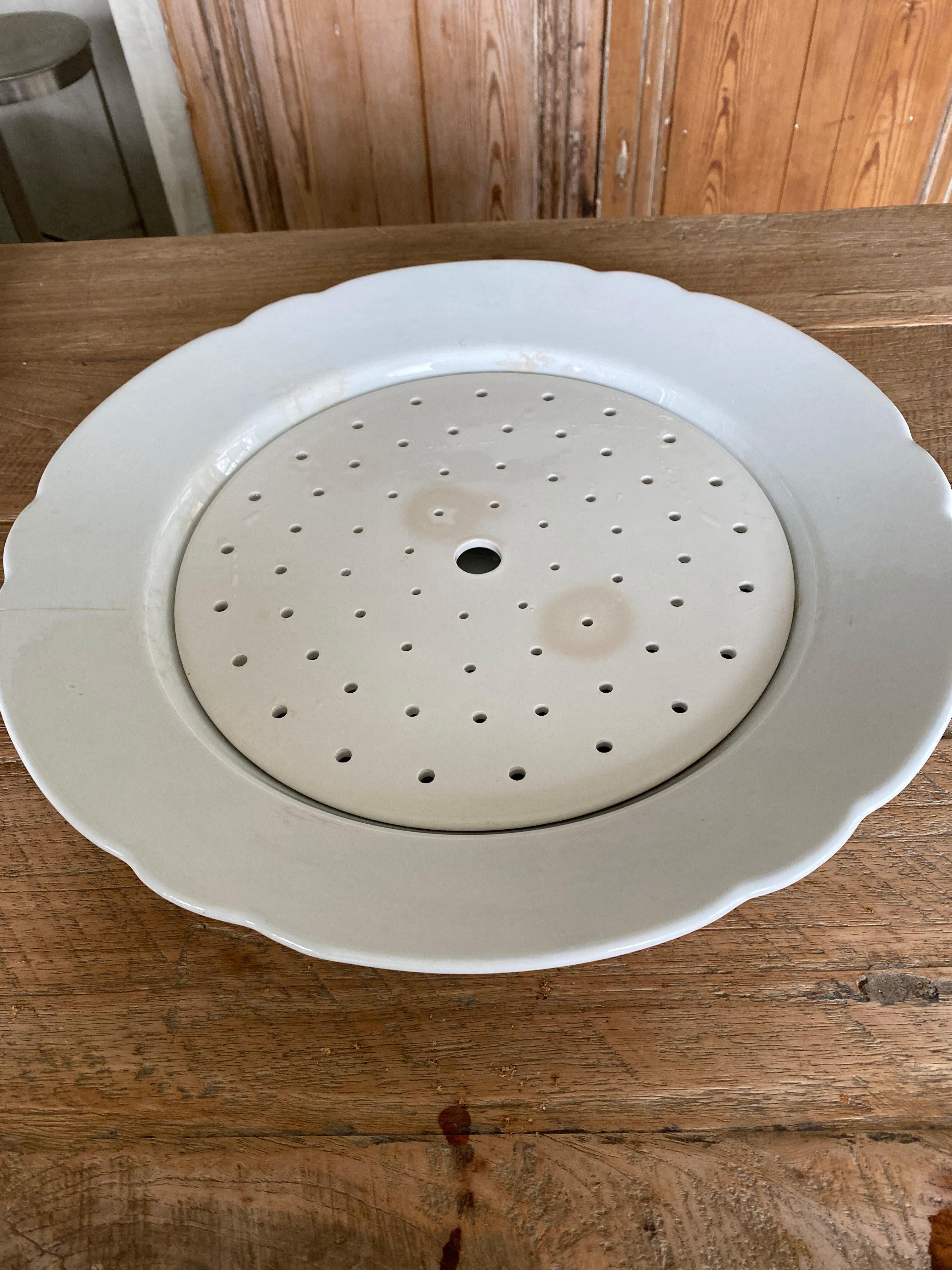 Add elegance to your dining experience. The large Dutch white ironstone meat or fish serving platter with drainer or drain plate dating from the end of the 19th century. Marked 