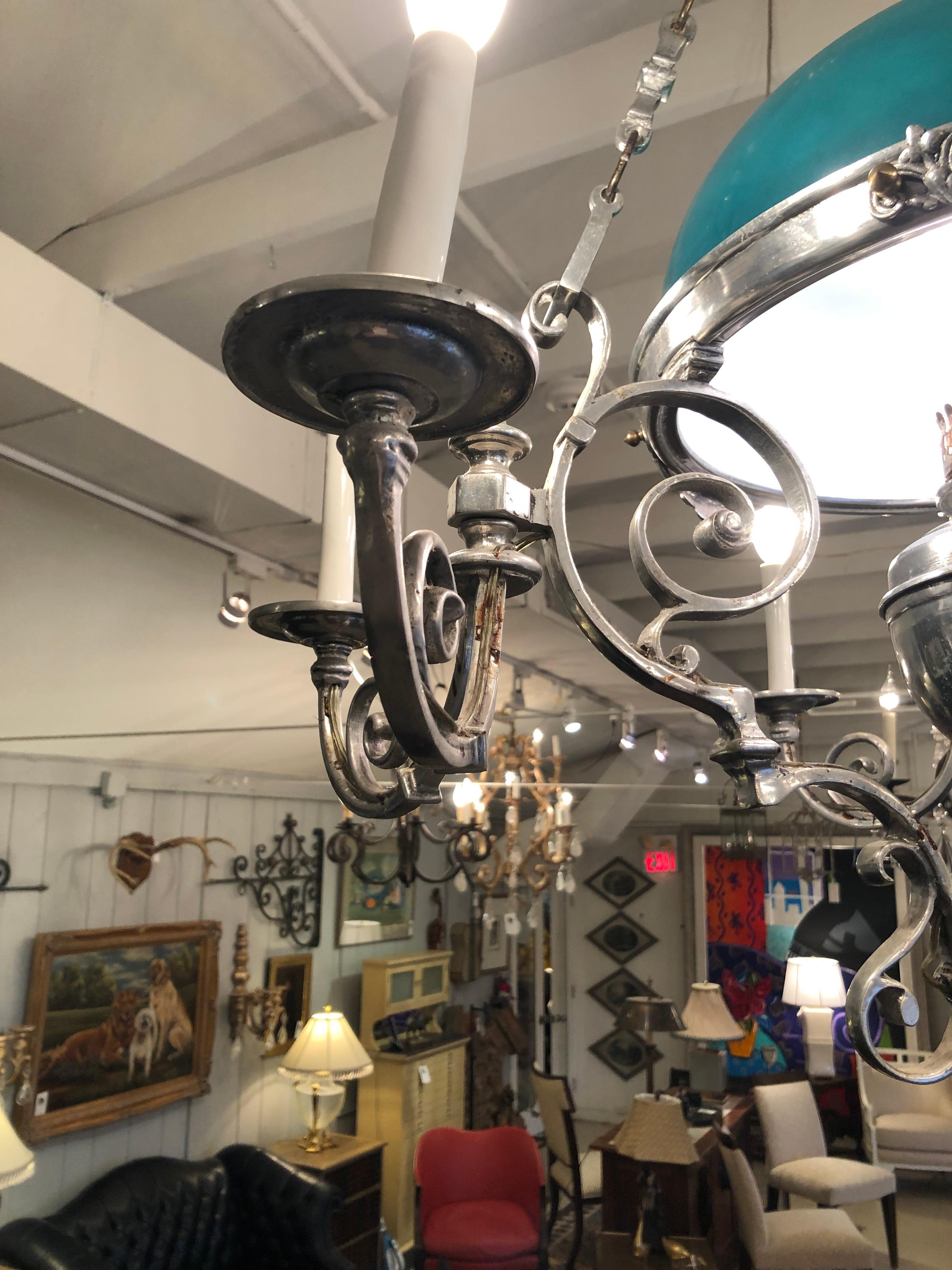 Impressive large antique pewter and green opaque glass domed chandelier that was once a period gas lamp having 6 lights, fancy curlicue arms, and beautiful figural decoration around the periphery.

Jones