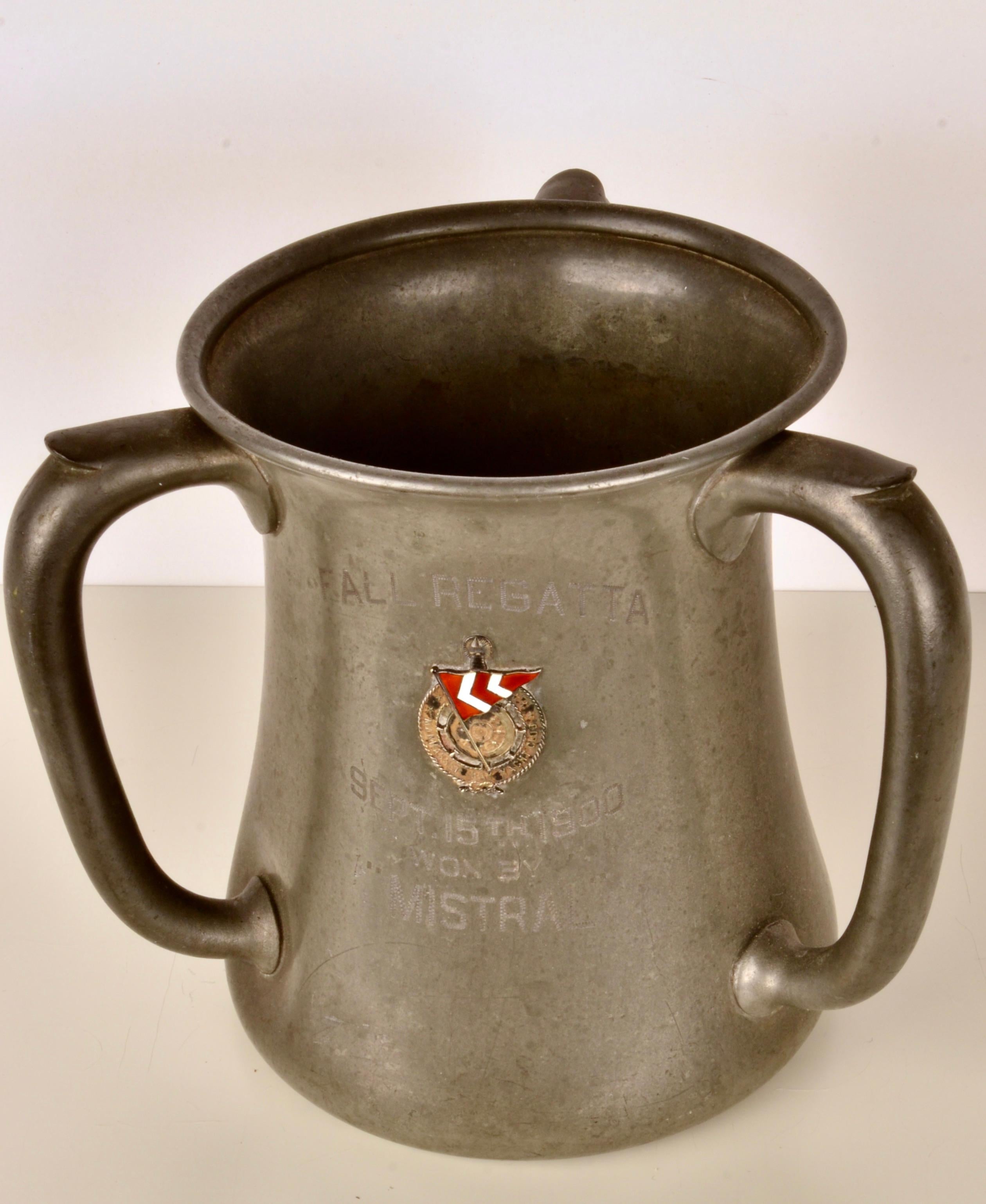 This pewter trophy was awarded to the Yacht Mistral for a win in the Manhassett Bay Yacht Club Fall Regatta in 1900. The prestigious MBYC was founded in 1891 and is still an active club today. The cup is in the traditional loving cup form and