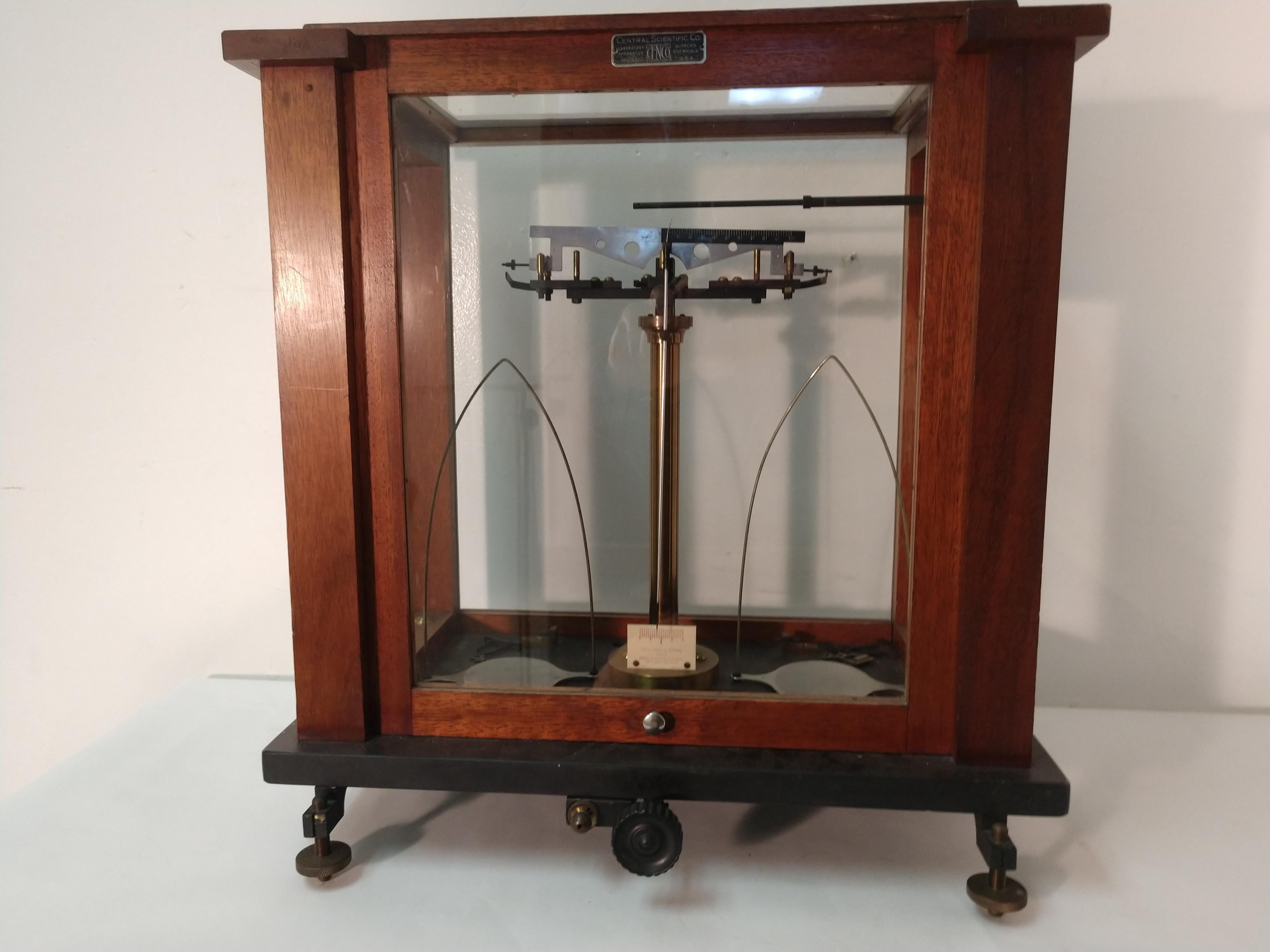 Fabulous early 20th century Pharmaceutical and minerals scale.In excellent vintage condition. Walnut and glass with a slate base creates the housing for the scale. Very cool decorative piece, door glides upward with ease.