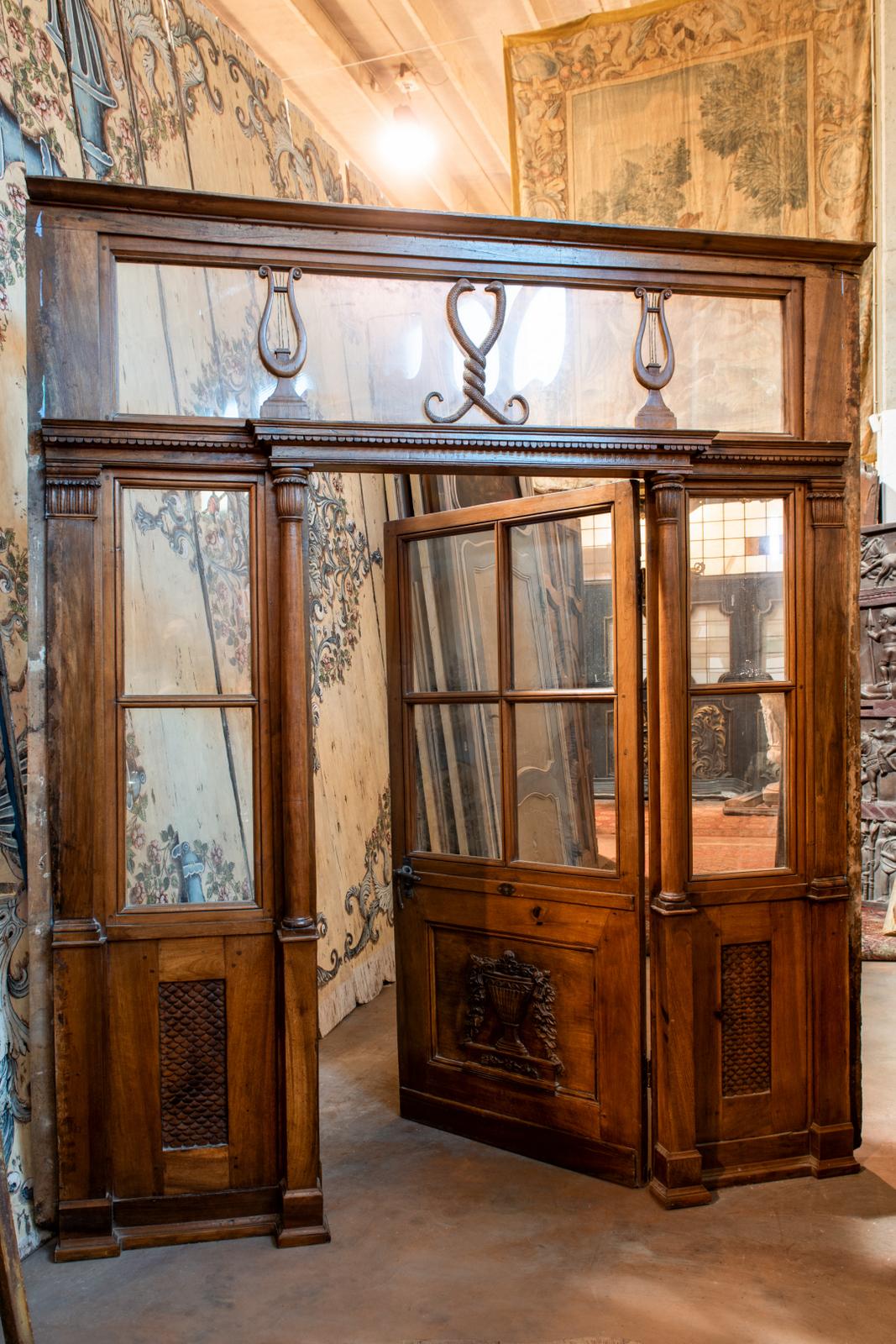 Antique glass door, from pharmacy entrance, carved with medical symbols, in beautiful and solid walnut, built and sculpted entirely by hand in the 19th century for a pharmacy shop in Piedmont, Italy.
It has already been conservatively restored,