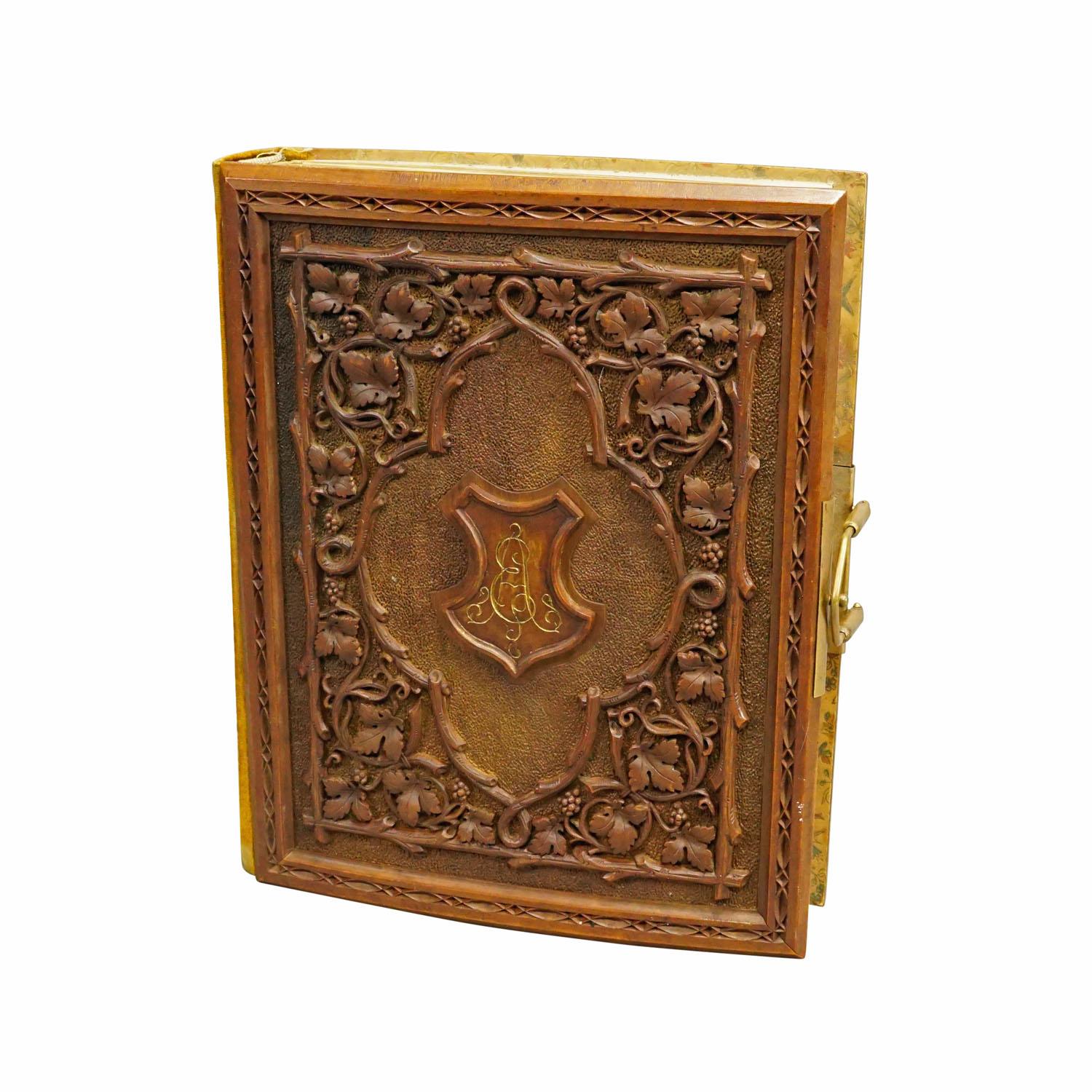 Antique Photo Album with Wooden Carved Cover, Brienz ca. 1900

A great antique photo album featuring a lindenwood carved cover depicting grapes, vines and a ligatured monogram. Handcarved in Brienz, Switzerland around 1900. Inside with spaces for