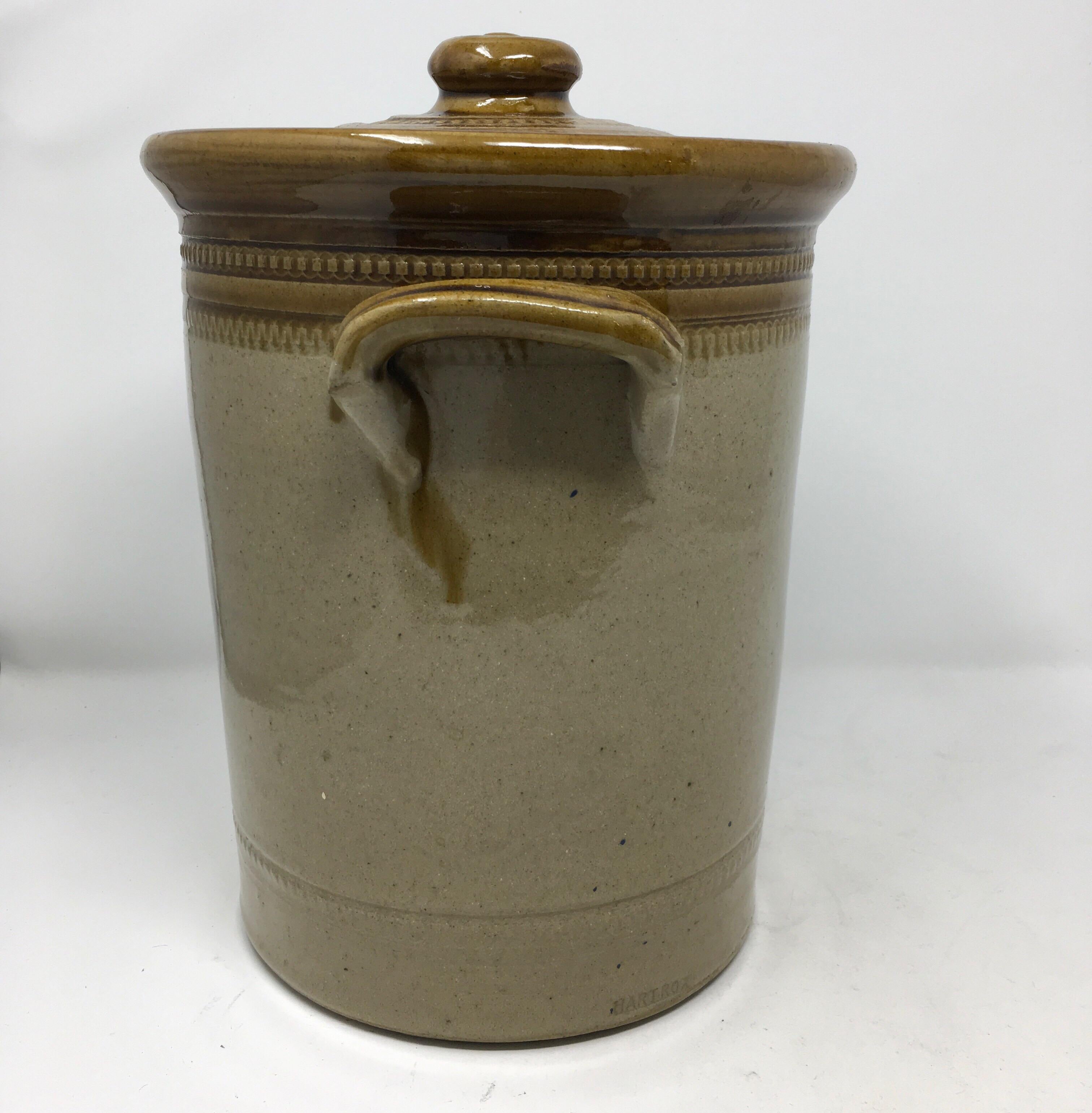 Imported from England, the transfer printed pickled egg crock circa 1920 has two handles and a pictorial of a hen and egg inside of a circle. There is impressed rouletting around and under the rim as well as along the bottom. The crock is complete