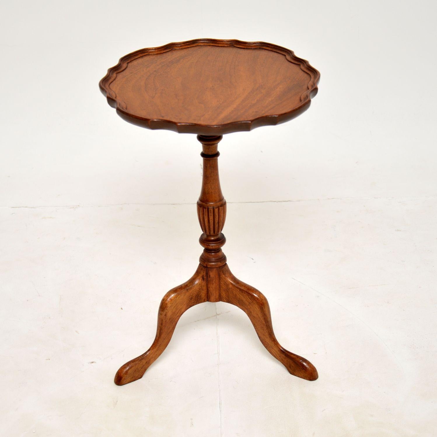 A lovely little antique wine table in wood. This is in the Georgian style, it was made in England and dates from around the 1930’s.

It is of lovely quality, with a pie crust edge, flame wood top and solid tripod base.

We have recently had this