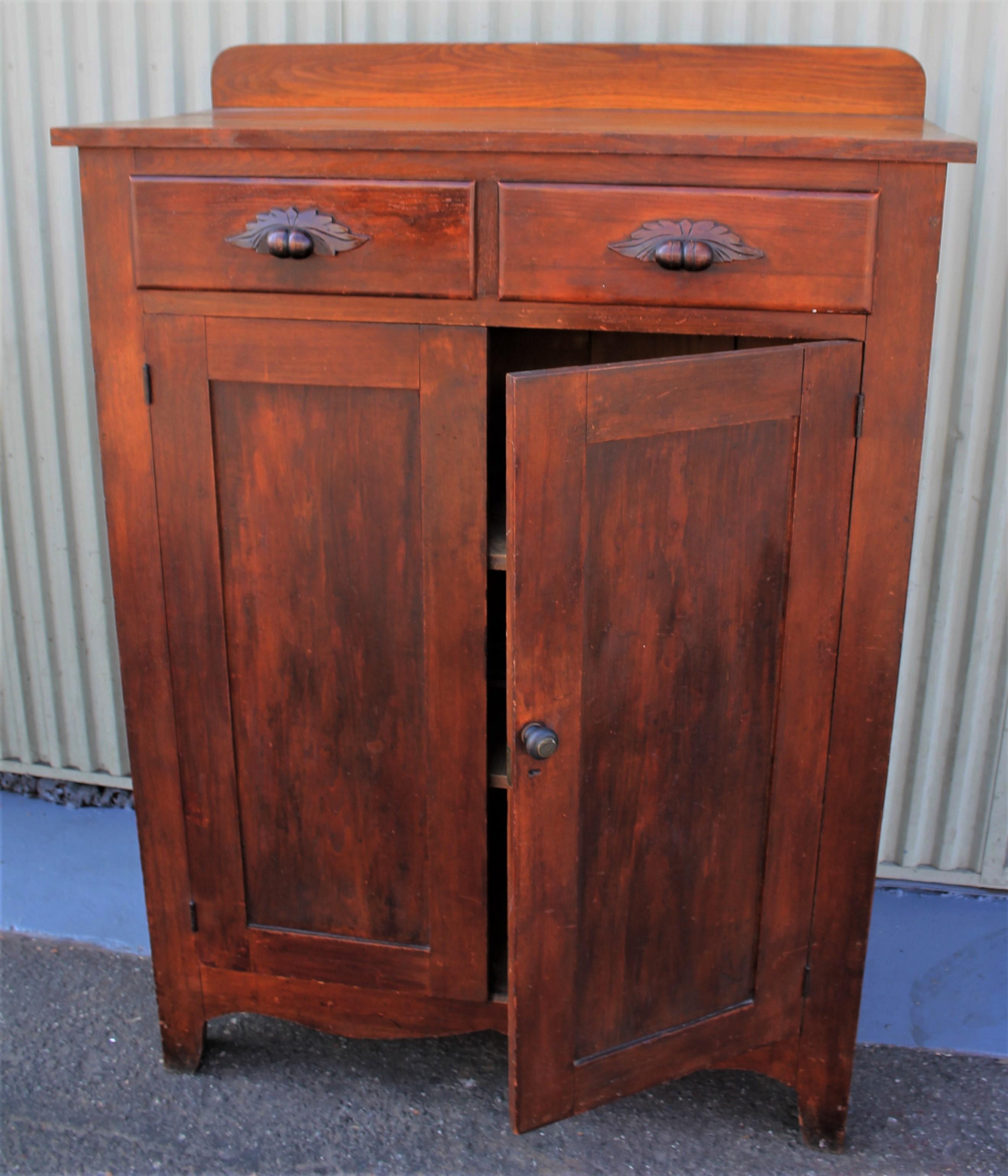 19th century pie safe in original stained surface. This beautiful pie safe has been checked for strength and stability. The cupboard is in fine condition and the original tins are good as well. Everything is all original.