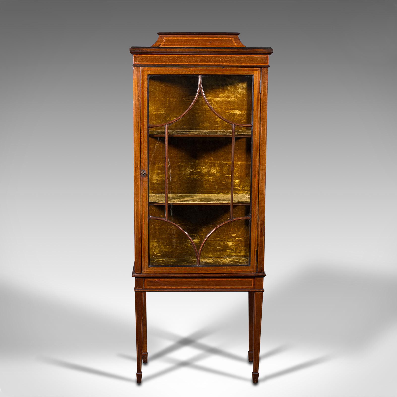 This is an antique pier cabinet on stand. An English, walnut and boxwood glazed display case, dating to the Edwardian period, circa 1910.

Attractive presentation and exuding quality
Displays a desirable aged patina and in good order
Select