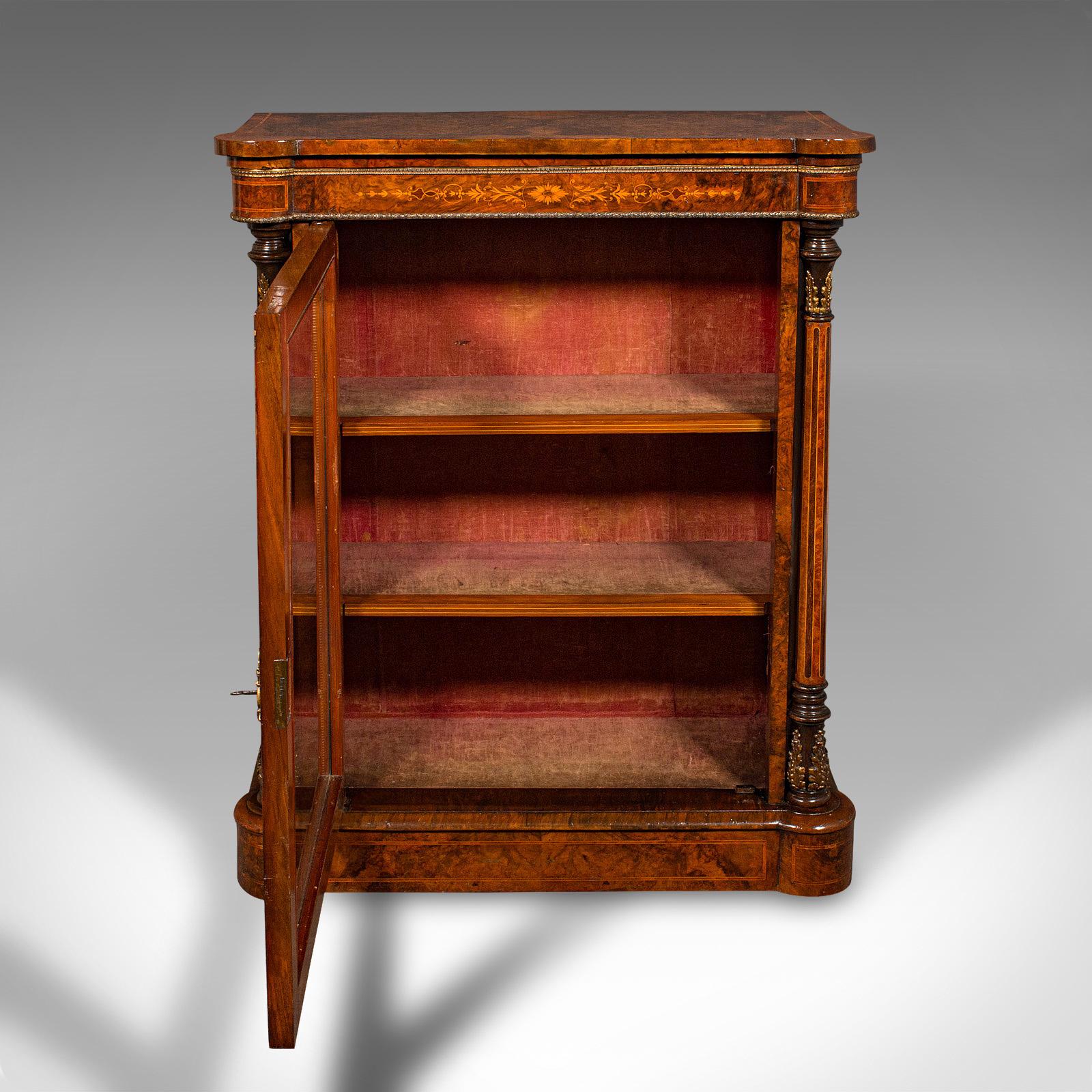 This is an antique pier display cabinet. An English, burr walnut and boxwood inlaid glazed bookcase or china cupboard, dating to the Regency period, circa 1820.

Majestic craftsmanship with exquisite colour and figuring
Displays a desirable aged