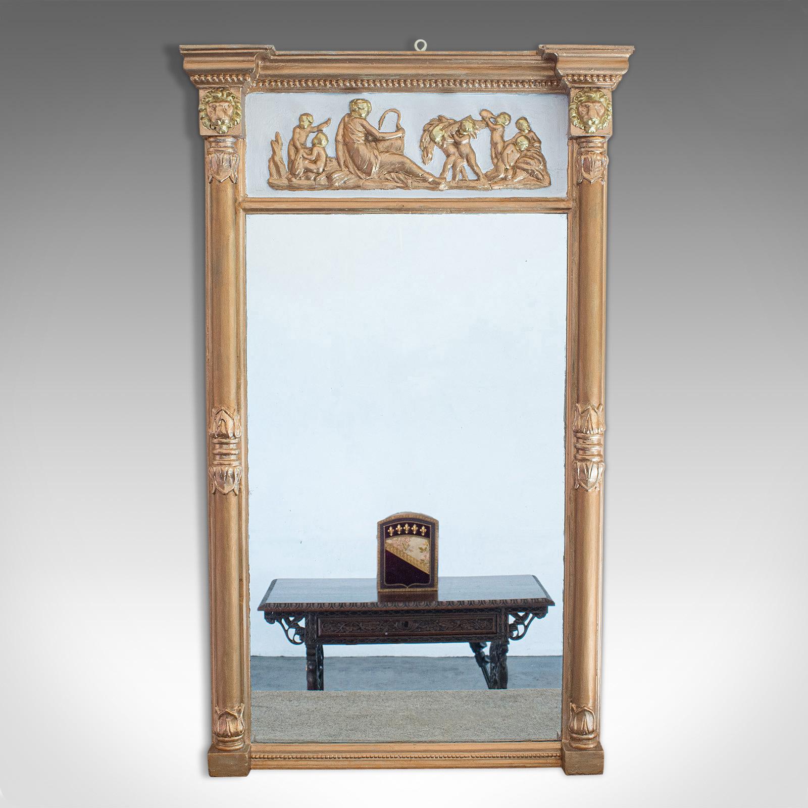 This is an antique pier glass mirror. An English, gilt gesso mirror in Classical taste, dating to the Regency period, circa 1820.

Bold frame with overt Classical influence
Displays a desirable aged patina
Gilt Gesso in good order with rich