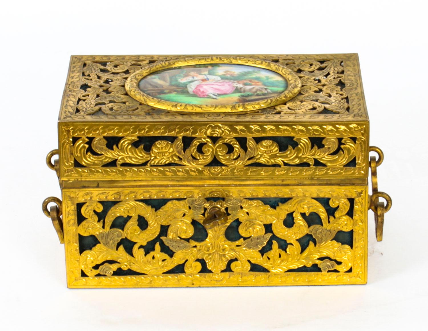 This is a stunning antique 19th century French Palais Royal pierced brass and porcelain mounted domed rectangular table casket , Circa 1870 in date. 

The locking cover enclosing velvet-lined interior, the whole cage work cast with two handles.