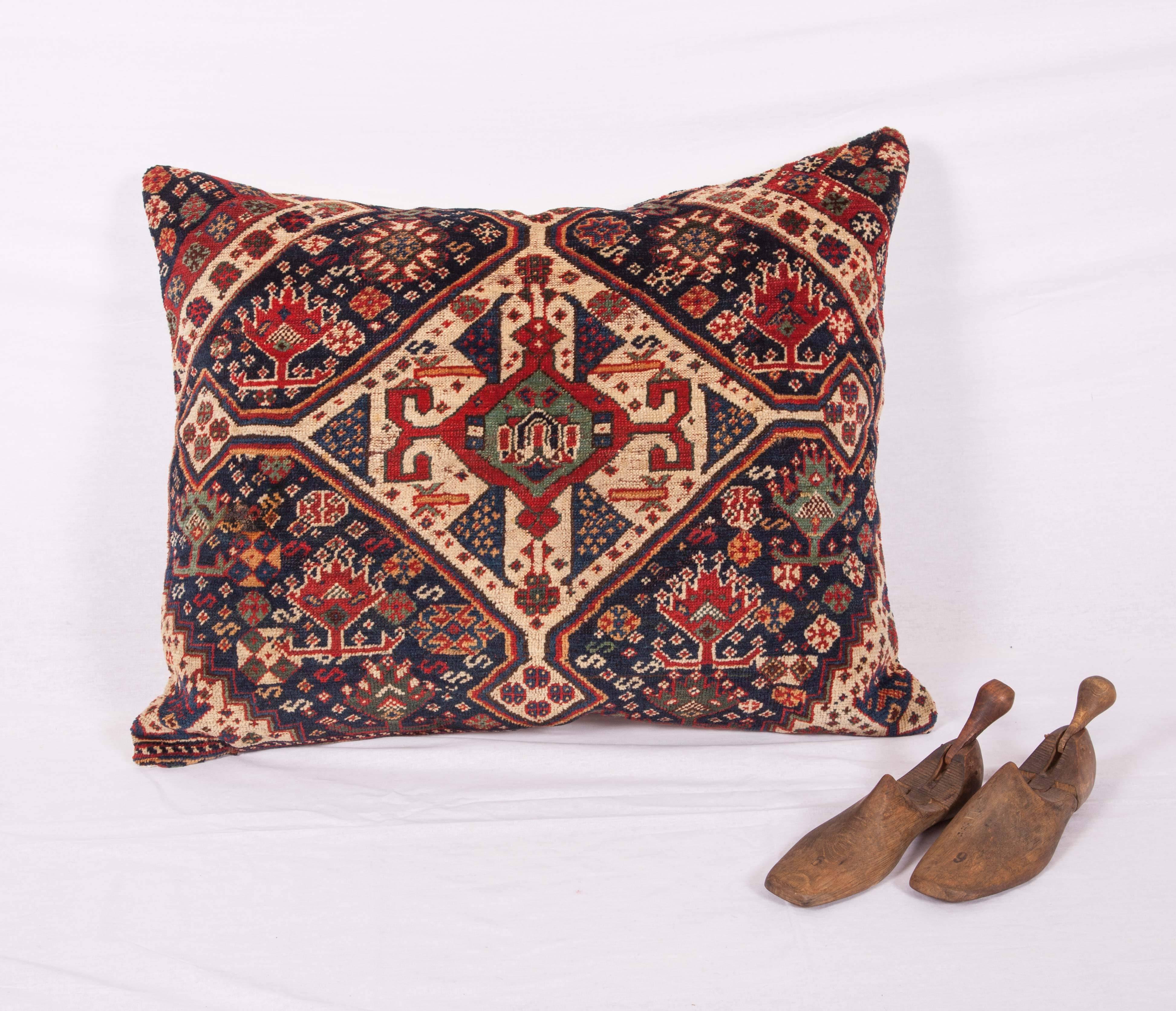 Antique pillow case fashioned from a 19th century. Kashgai wool rug fragment. It does not come with an insert but it comes with a bag made to the size and out of cotton to accommodate the filling. The backing is made of linen. Please note 'filling