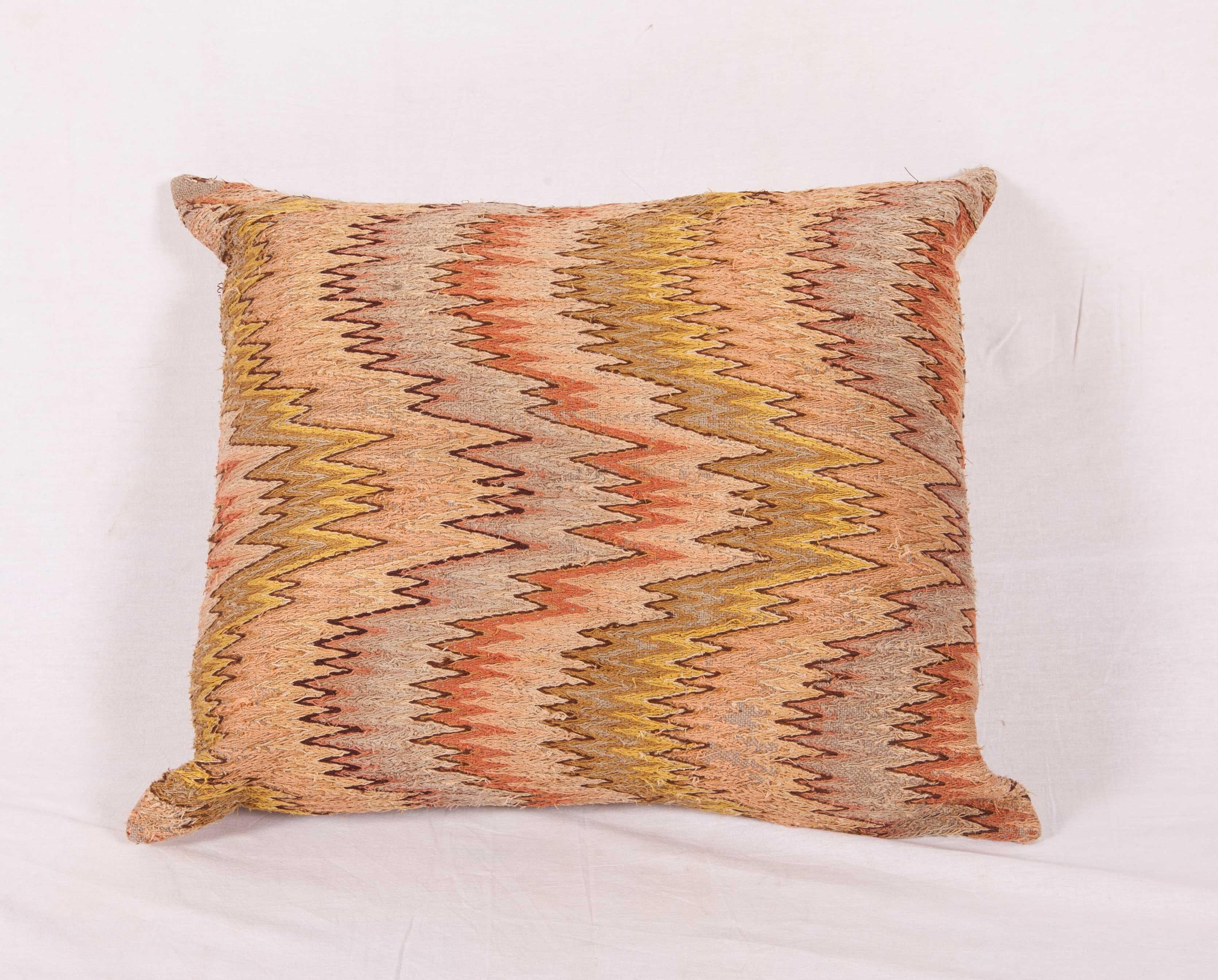 The pillow case is made out of a 18th-19th century. Italian Bargello flame stitched panel. It does not come with an insert but it comes with a bag made to the size and out of cotton to accommodate the filling. The backing is made of linen. Please