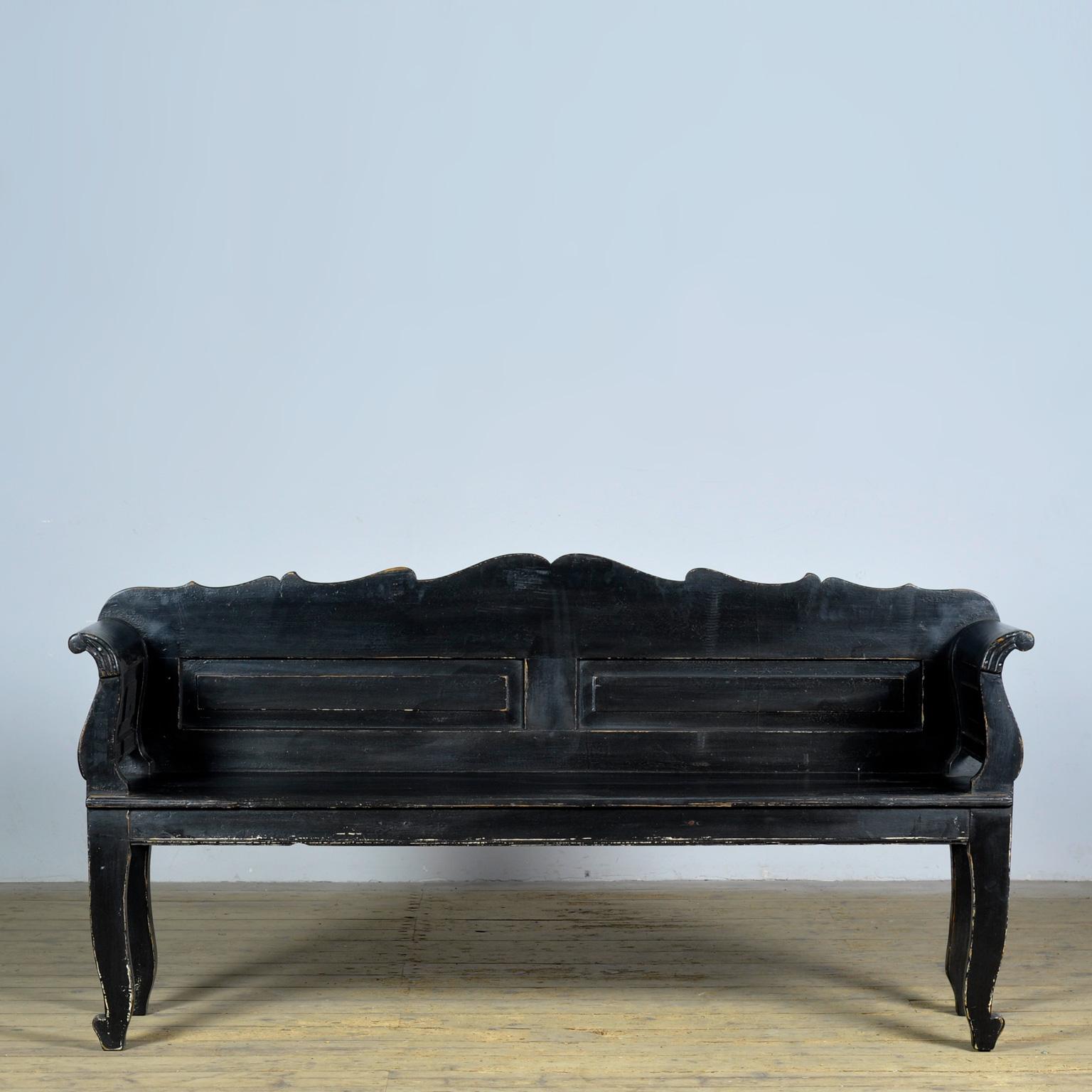 A charming bench from Hungary with the original paint. The bench was made around 1900. Over time, time and use, the black paint has worn away to the wood in places. Free of woodworm.