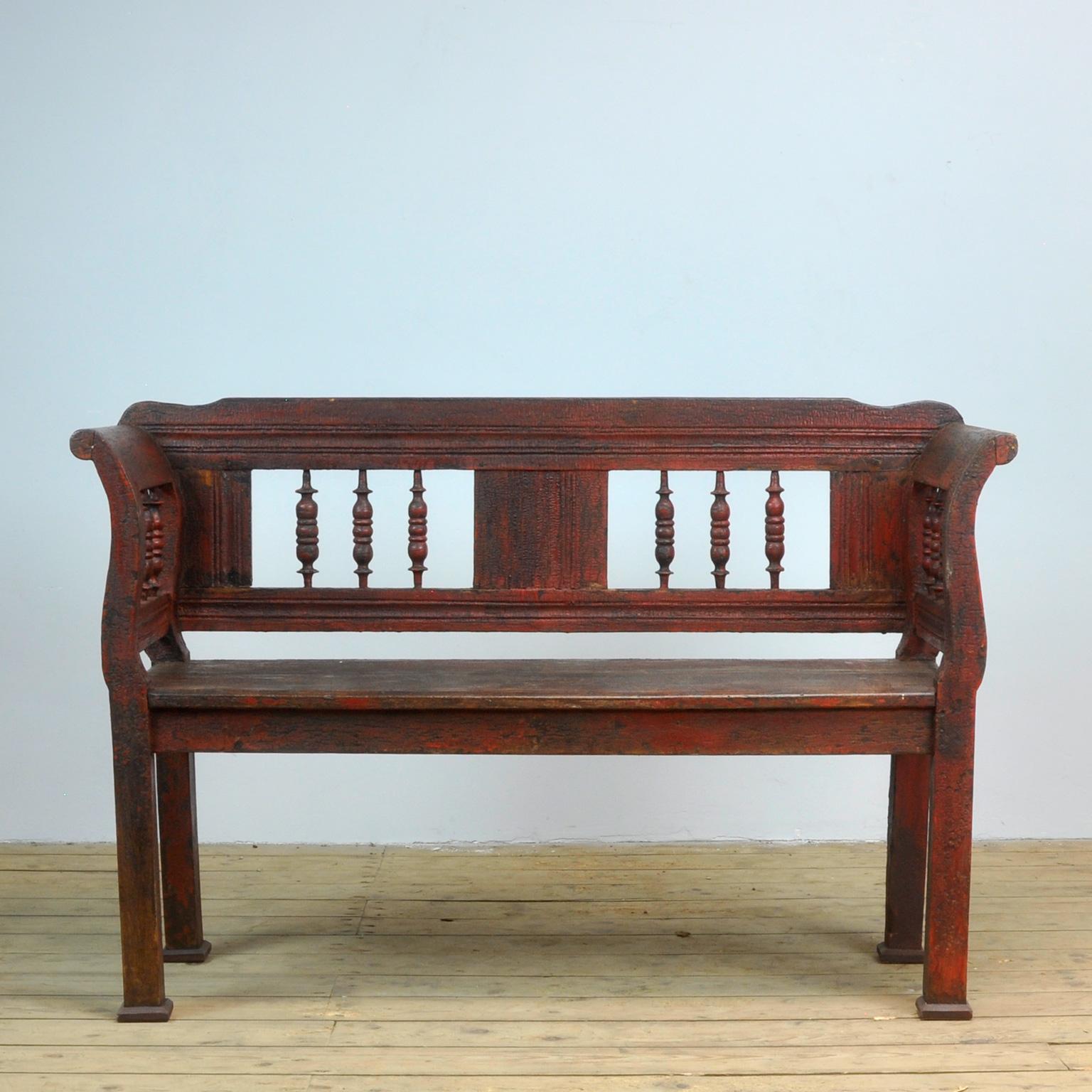 A charming bench from Hungary, painted a striking shade of red with great patina. Original paint.