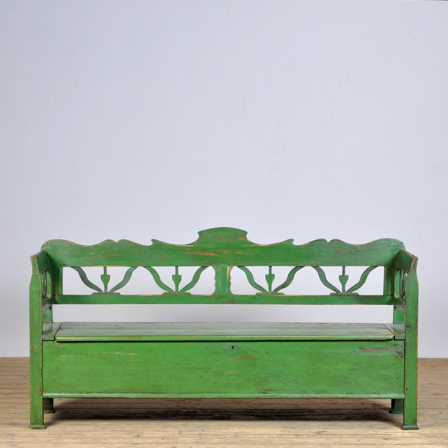A charming bench from Hungary with the original paint. Over time and use, the green paint has been worn away in places to the wood. With storage space under the seat. The bench is stable and sturdy. Free of woodworm.