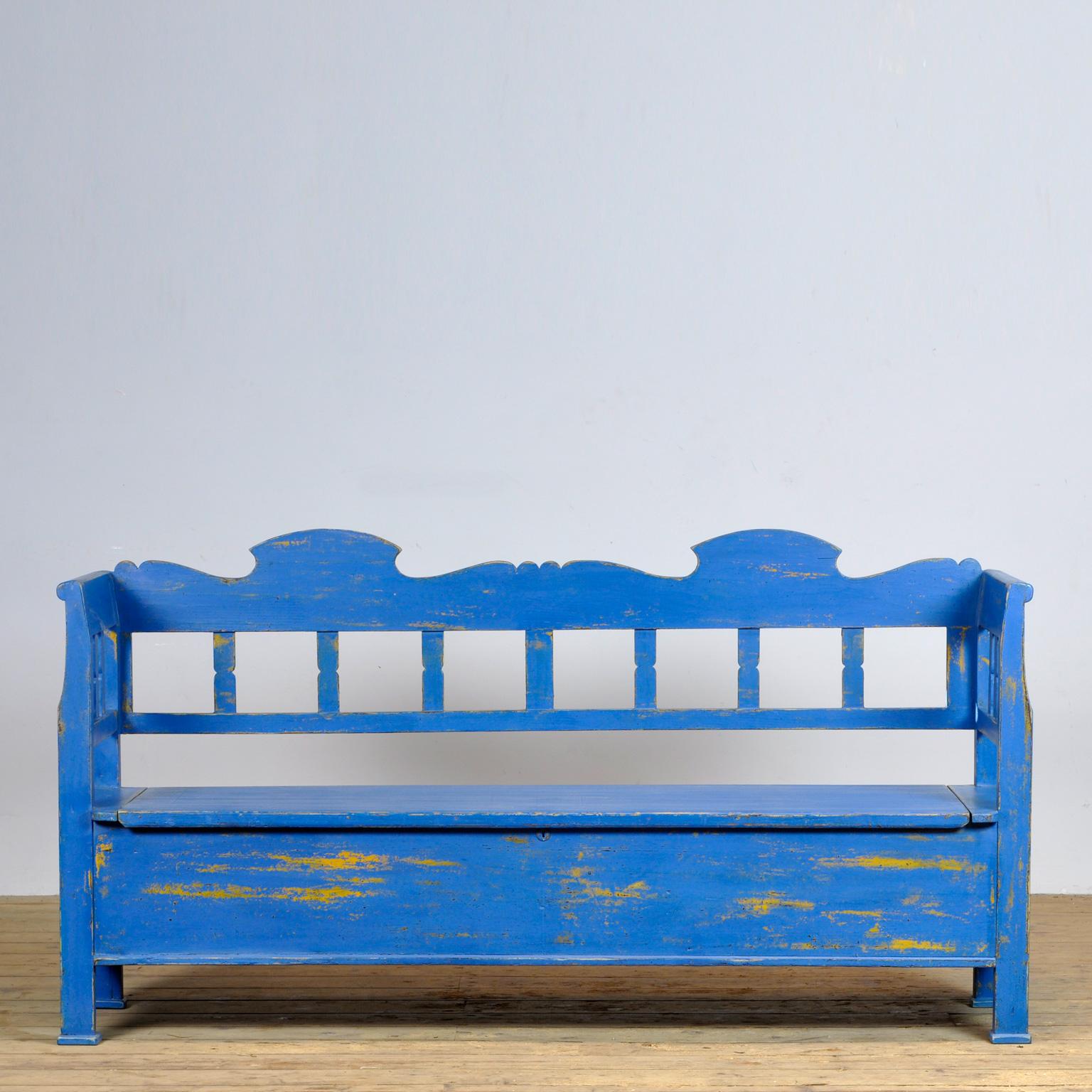 A charming bench from Hungary with the original paint. Over time and use, the blue paint has been worn away in places to the wood. With storage space under the seat. The bench is stable and sturdy. Free of woodworm.