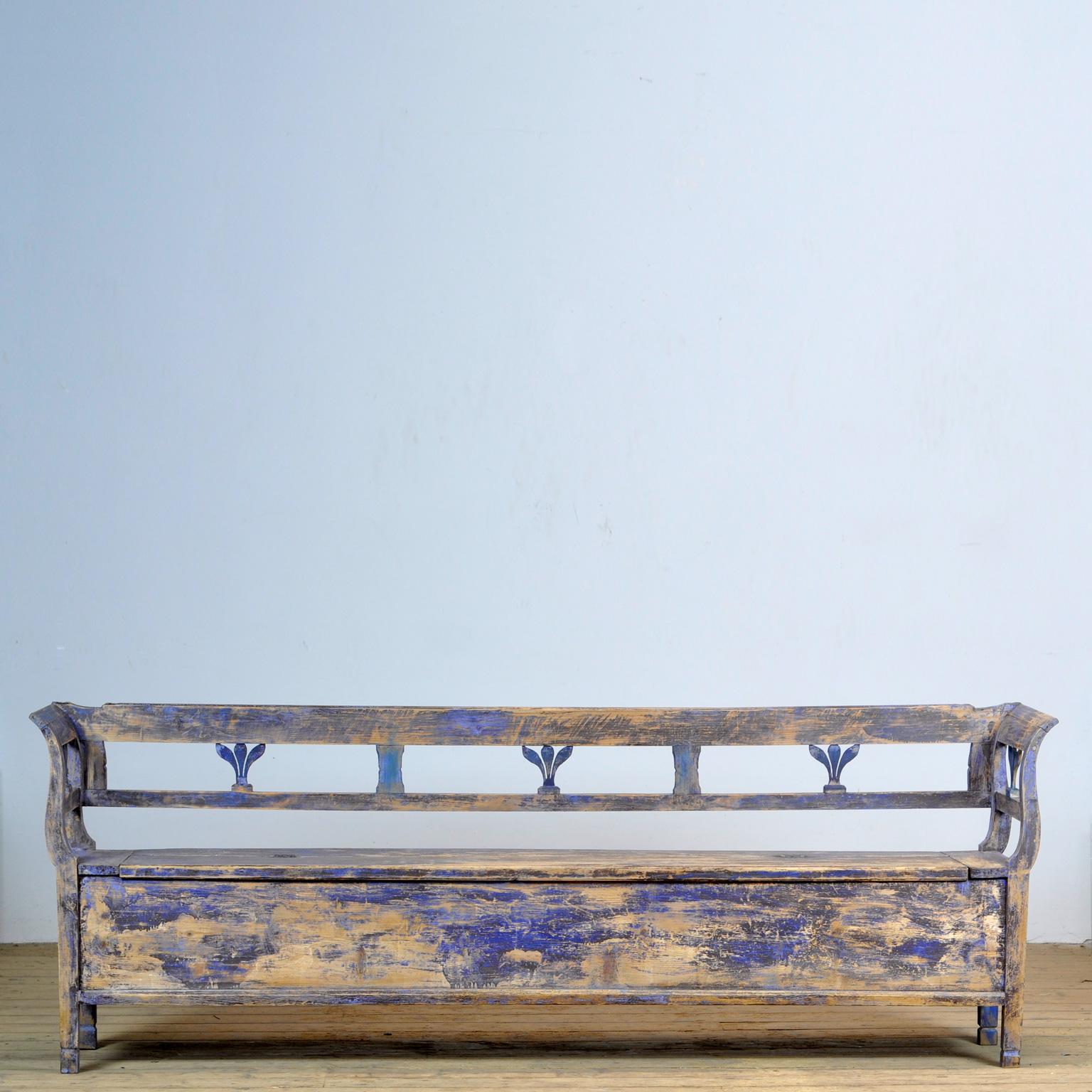 A charming bench from Hungary. Over time and use, the blue paint has been worn away in places to the wood. With storage space under the seat. The bench is stable and sturdy. Free of woodworm.