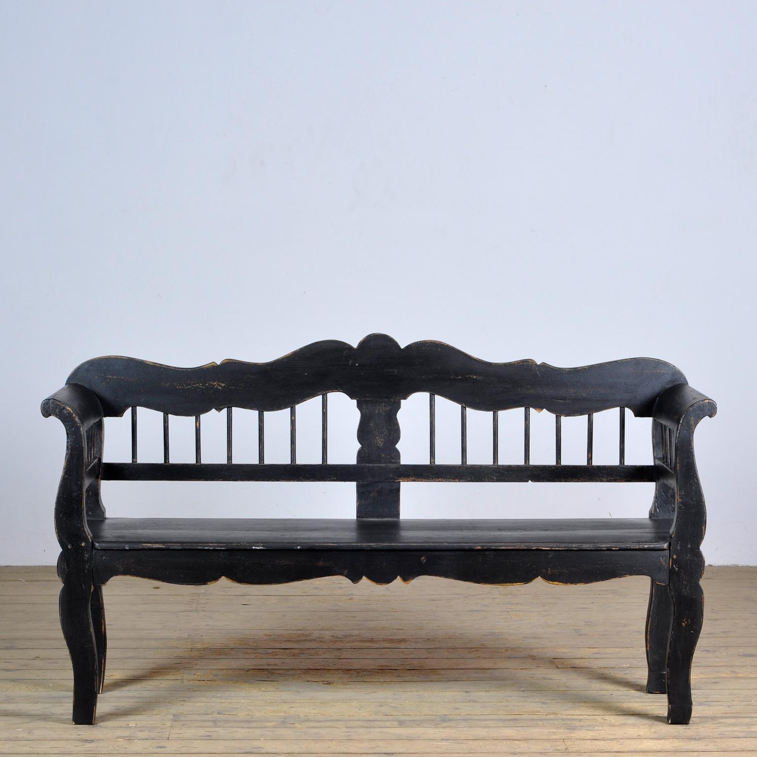 A charming bench from hungary with the original paint. Over time and use, the black paint has been worn away in places to the wood. The bench is stable and sturdy. Free of woodworm.