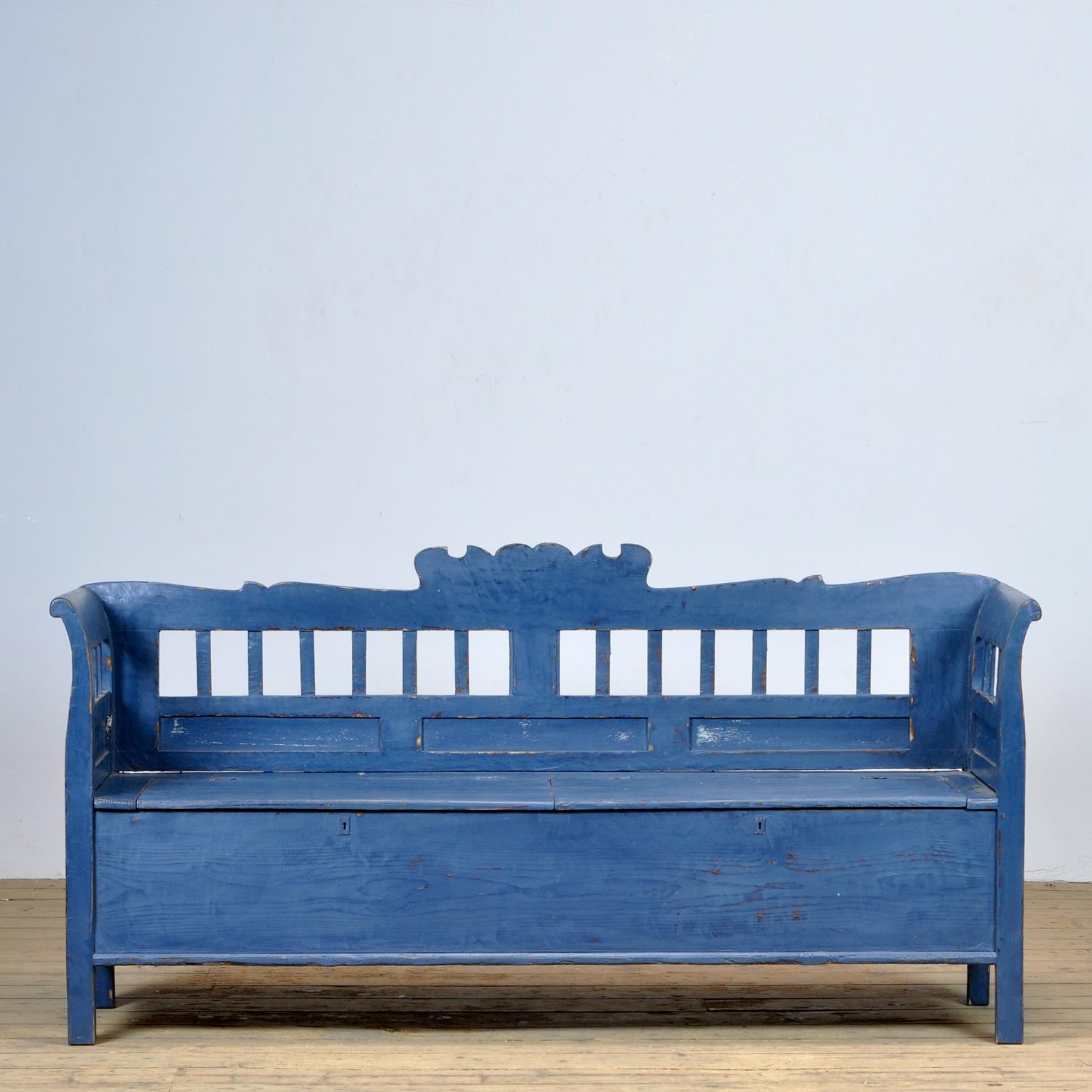 A charming bench from hungary with the original paint. Over time and use, the blue paint has been worn away in places to the wood. With storage space under the seat, divided in two compartments. The bench is stable and sturdy. Free of woodworm. 